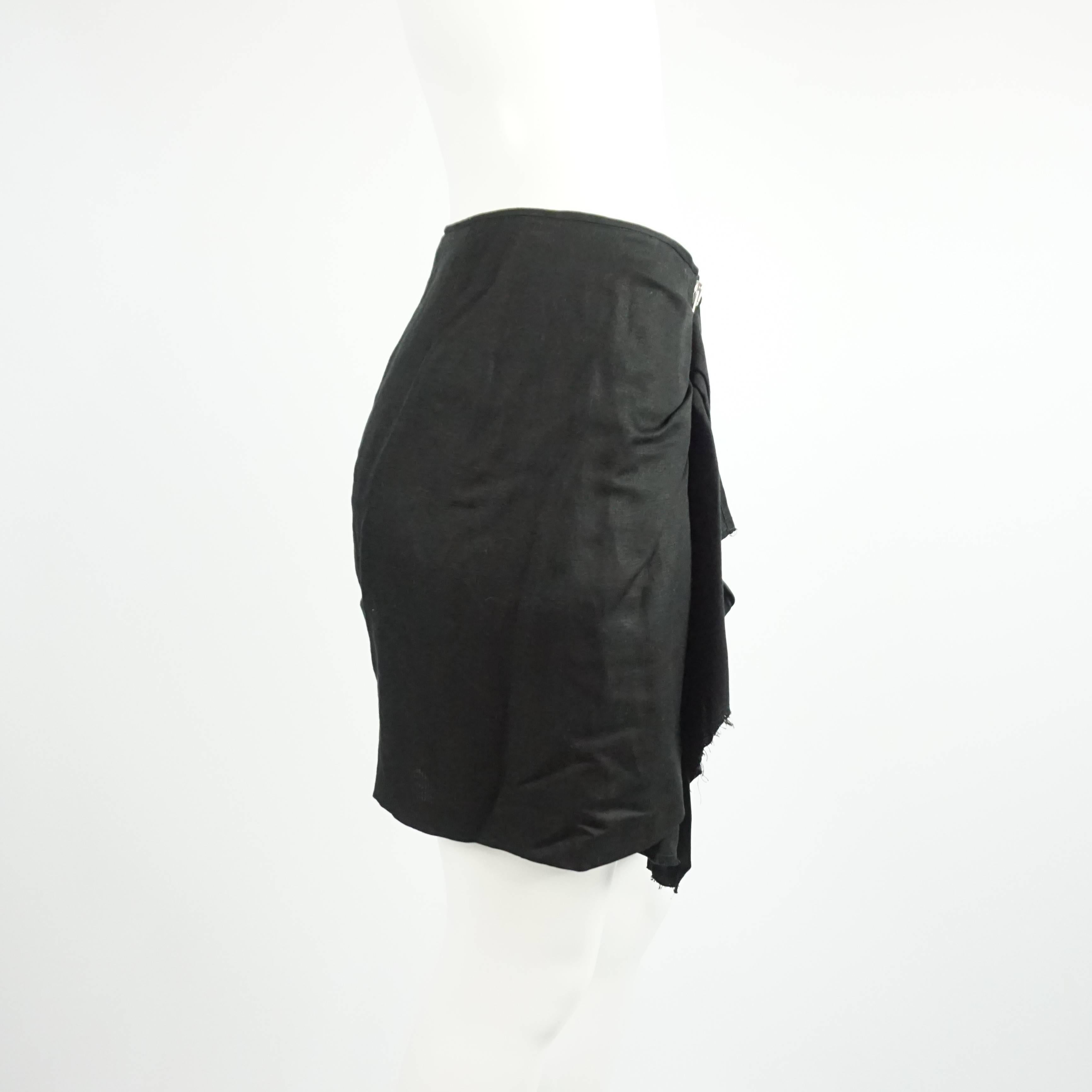 This stunning Isabel Marant skirt is made of black cotton and has a edgy look. The deconstructed skirt features an asymmetrical cut, rushing, and a silver zipper. It is in excellent condition with minimal wear. Size 3, circa 21st
