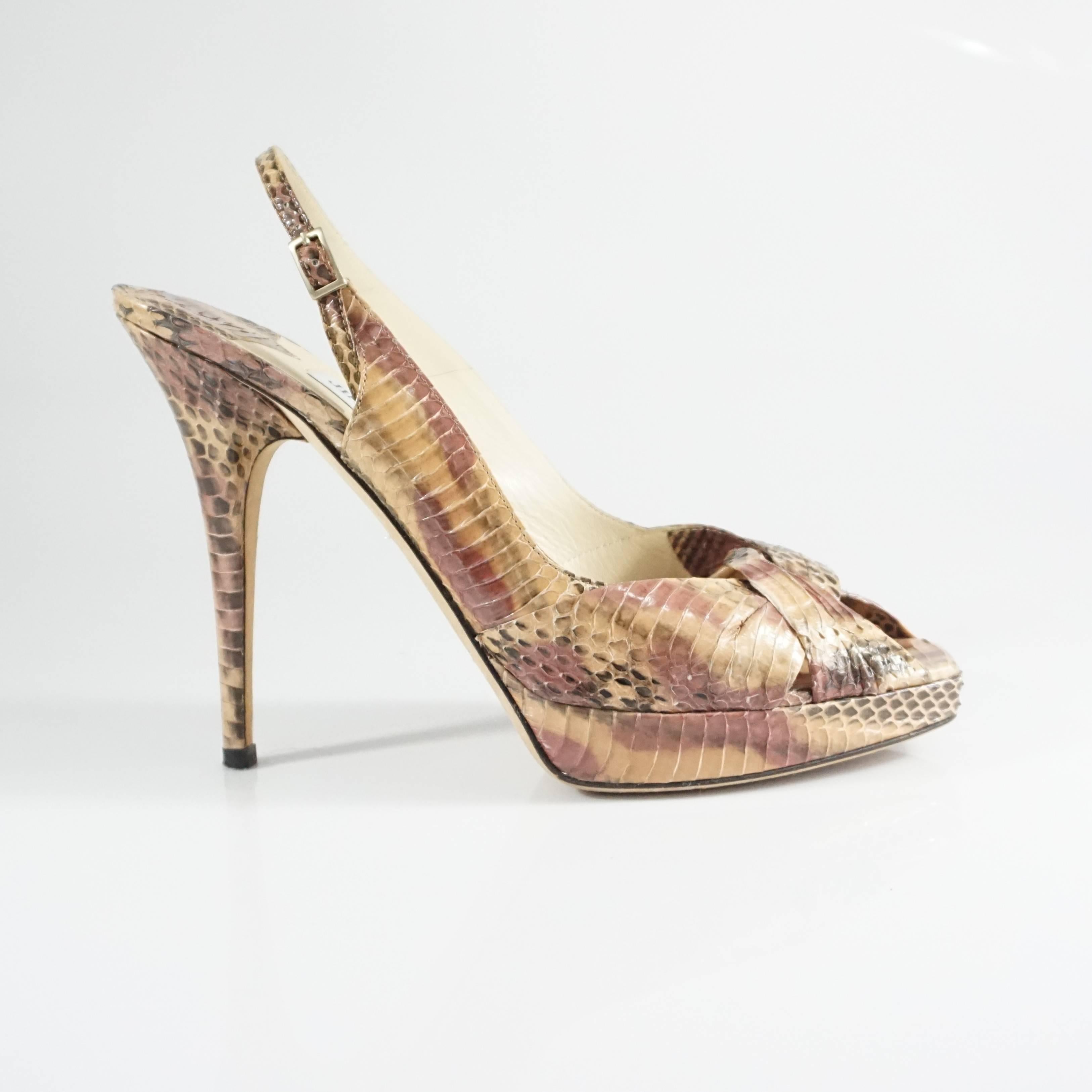These Jimmy Choo heels have a unique look. They feature a crossing toe bed, platform, and slingback. The shoes are in very good condition with minimal bottom wear and some pulling of the snake scales as seen in the last images. 

Platform:
Heel: