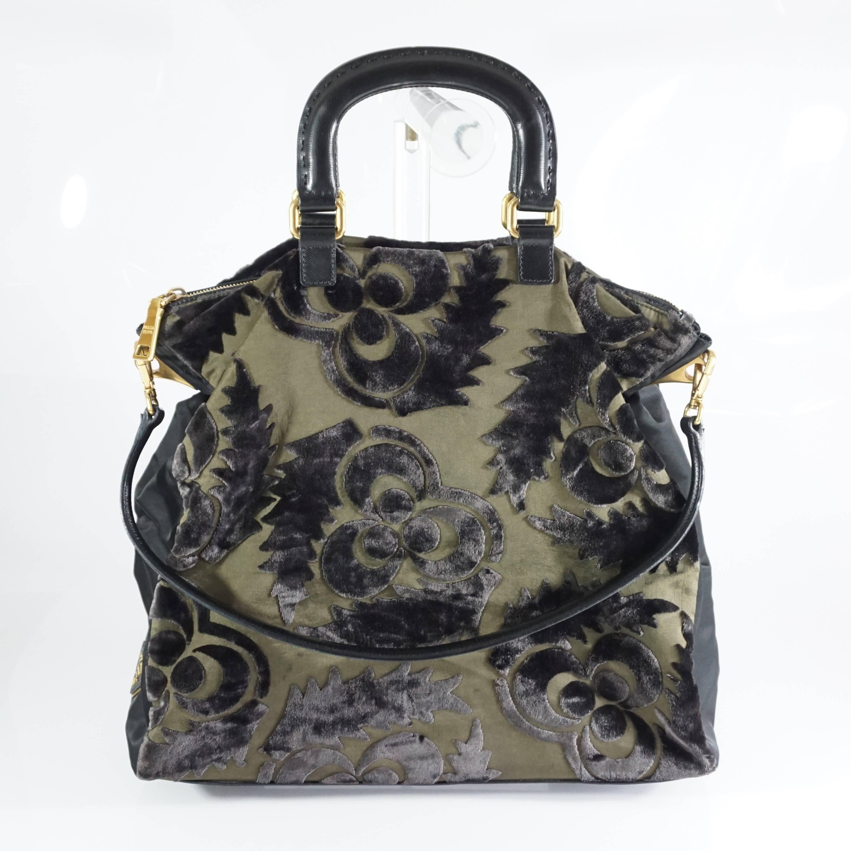 This Prada cut velvet bag is a unique piece. It features a floral velvet design, black nylon sides, black saffiano leather handles, and a shoulder strap. The bag is in good condition with a couple small blemishes on the fabric and a mark on the