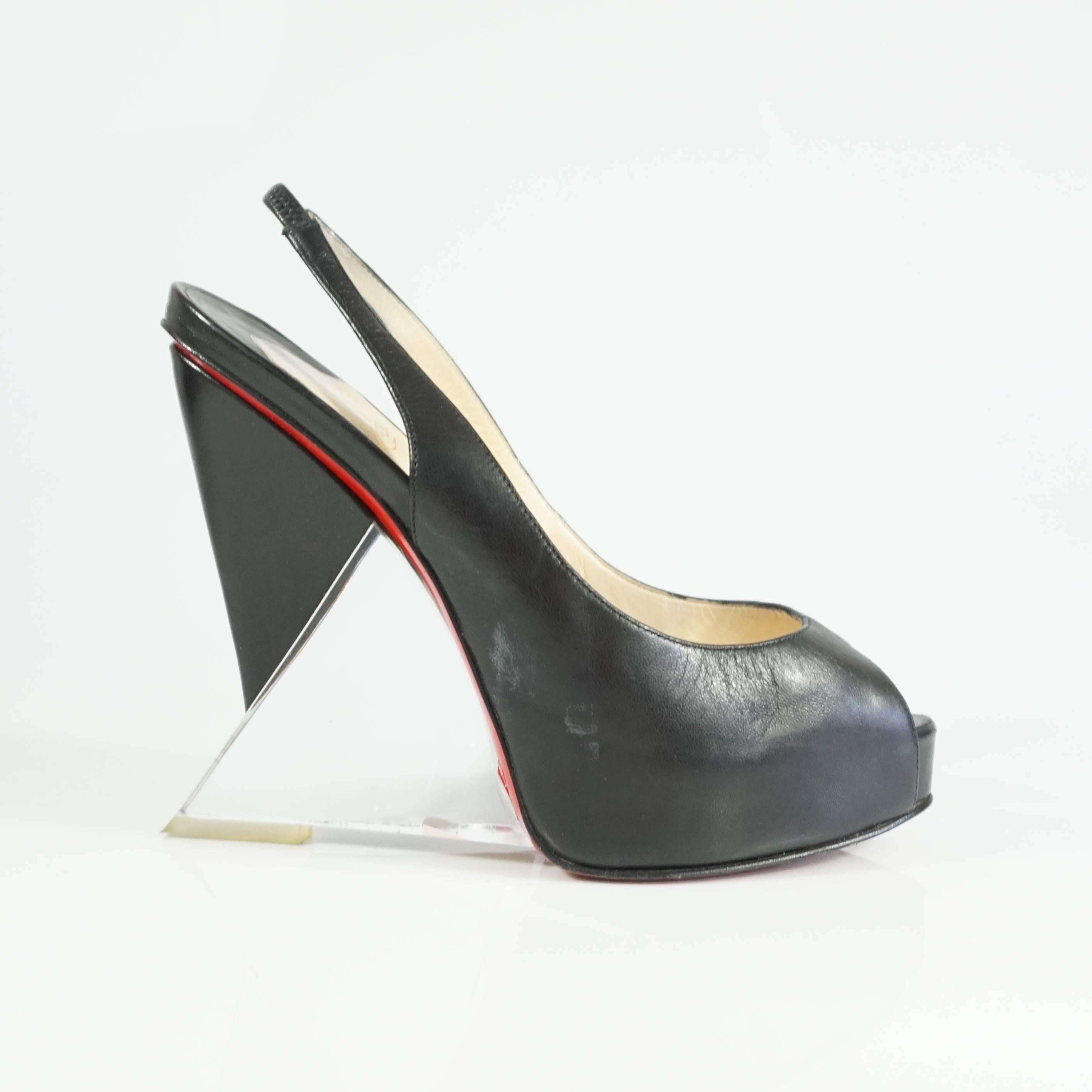 Christian Louboutin Black Leather and Lucite Slingback Peeptoe Platform - 37.5  These oh so fabulous Louboutins are truly a work of art. The black peeptoe silingback has a artistic leather and lucite combo wedge heel. The Shoe is in good condition