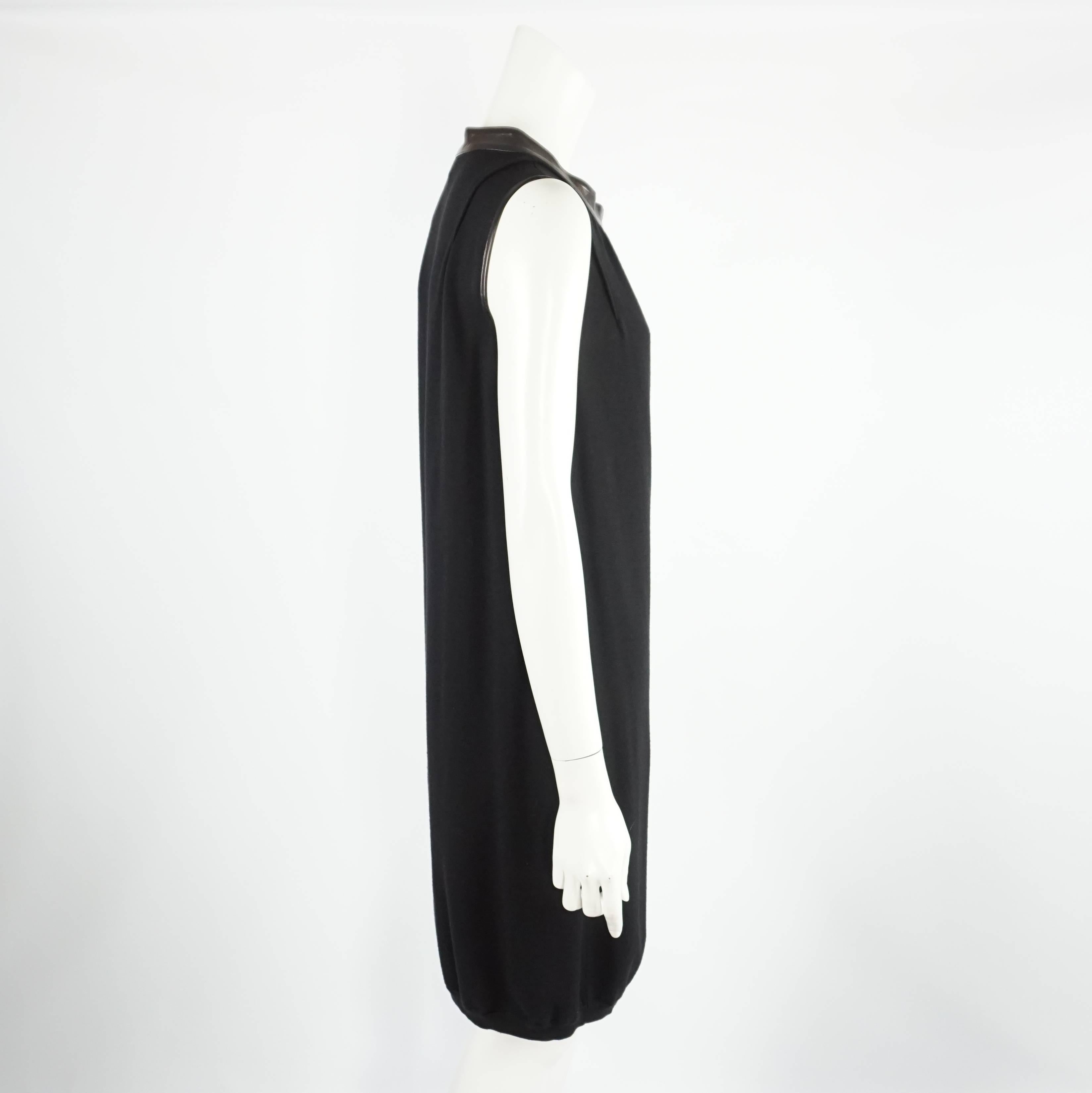 Yves Saint Laurent Black Wool Knt Sleeveless Dress - M  This Merino Wool Shift dress has a leather neckline and detail at armhole. This dress is in excellent condition. Size M

Measurements:
Bust: 40