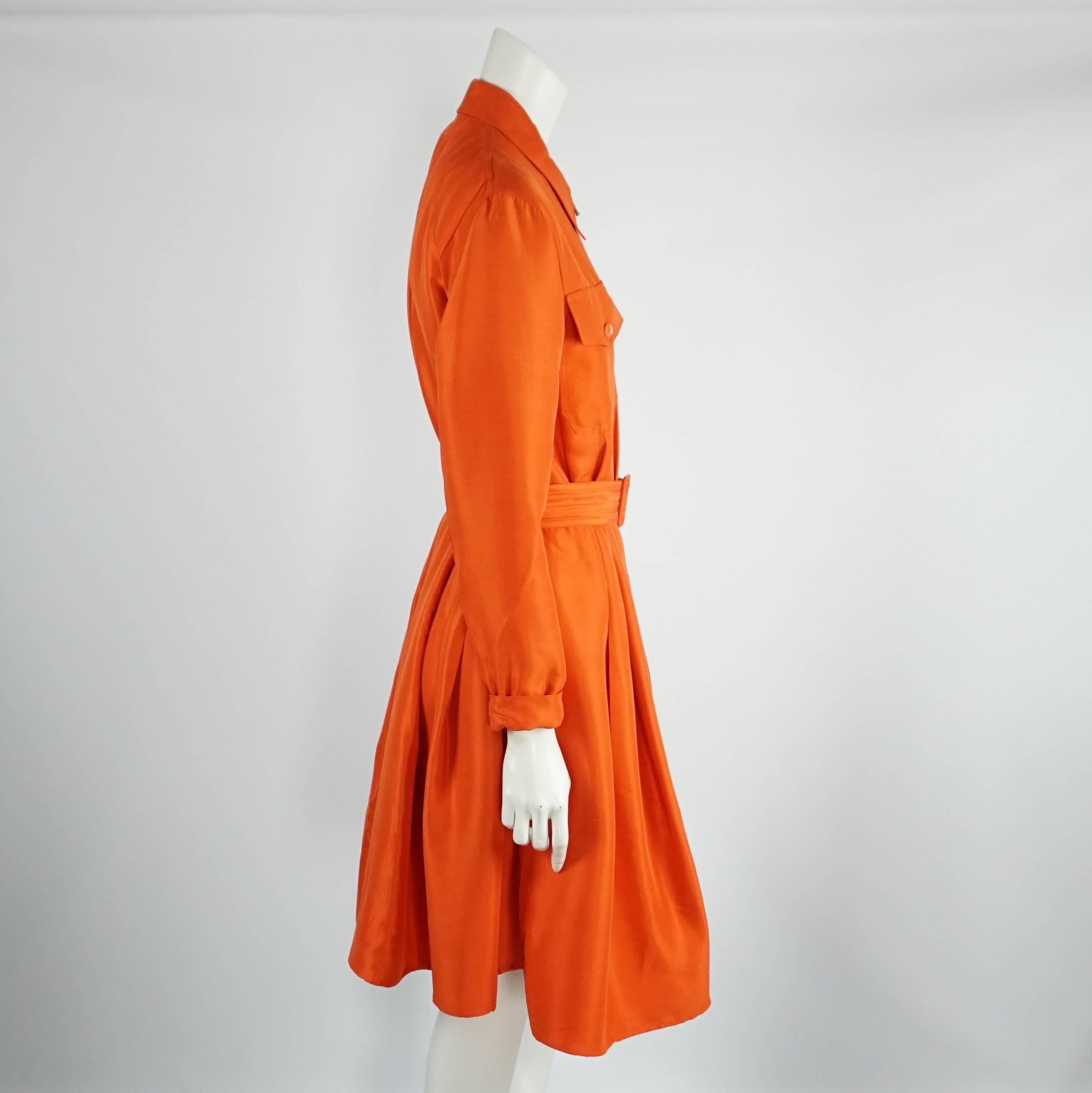 Ralph Lauren Purple Label Orange Long Sleeve Silk Dress - 8 This beautiful and elegant orange silk dress has a gold zipper running down the front from top to bottom and functioning on both ends, long sleeves with a cuff, 2 front pockets on the chest