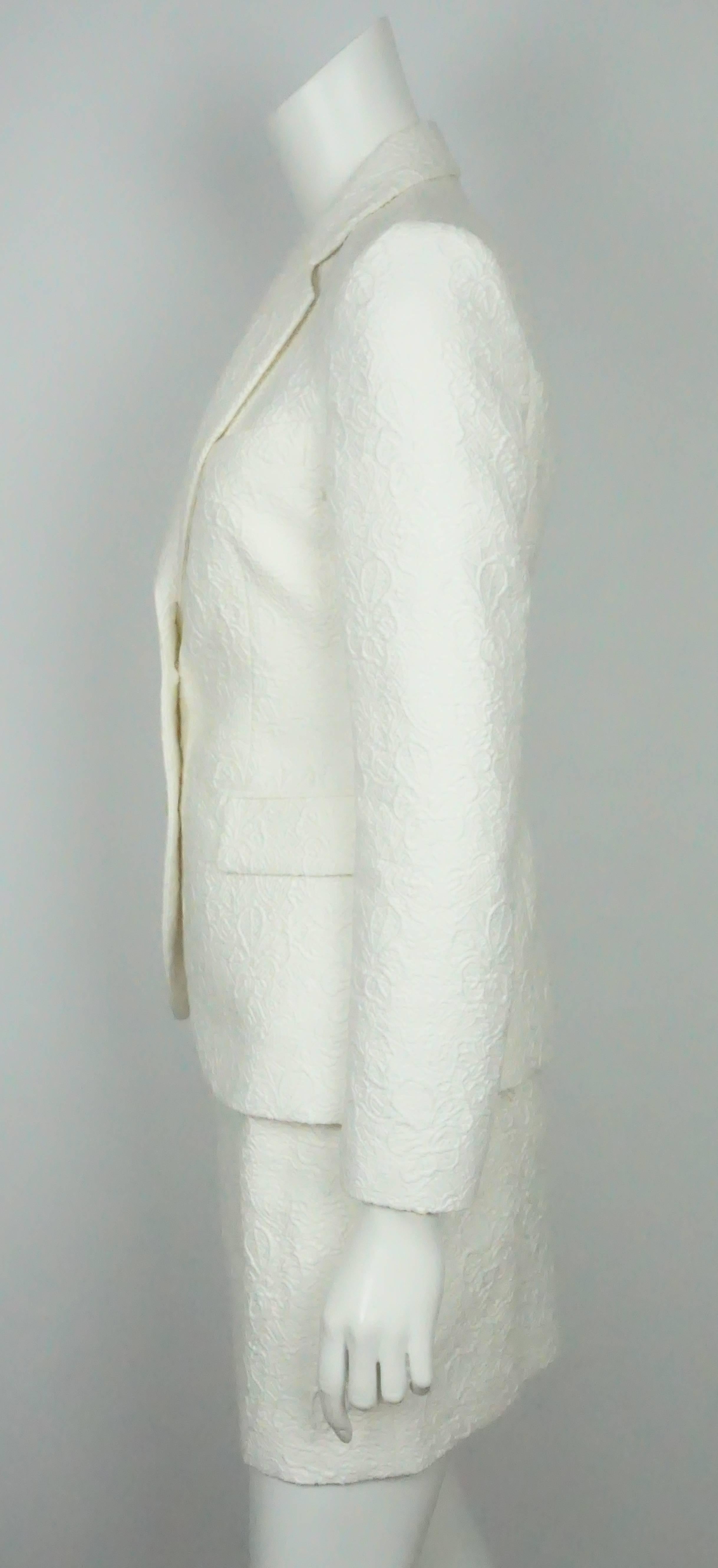 Emilio Pucci Ivory Textured Cotton/Silk Jacket and Skirt - 6-NWT  This elegant ivory cotton/silk skirt suit was never worn before. It has a quilted texture that shapes into a floral design. On the jacket there are two functional  front pockets with