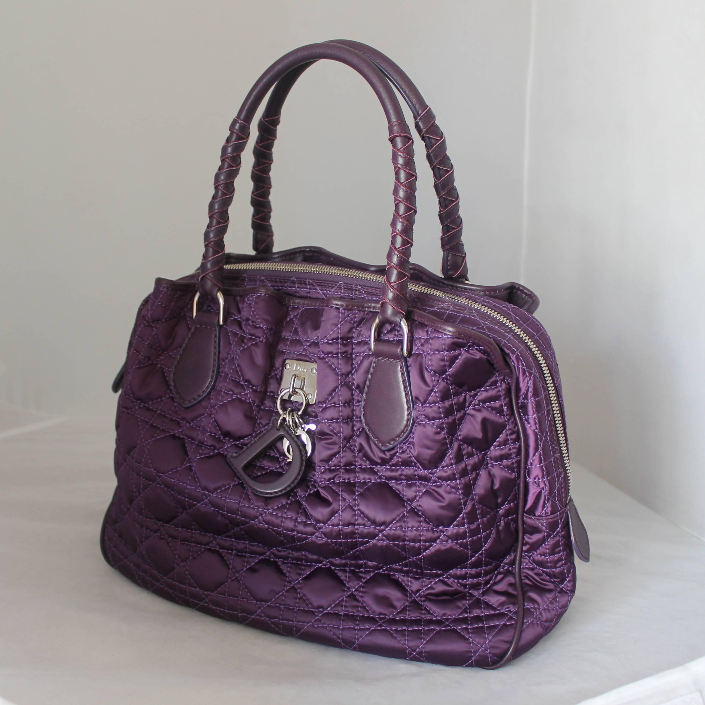 Christian Dior Purple Quilted Fabric Bag with Hanging Charms SHW. This bag is in excellent condition and has leather handles. The fabric is most likely a nylon material. 

Measurements:
Height- 10.25