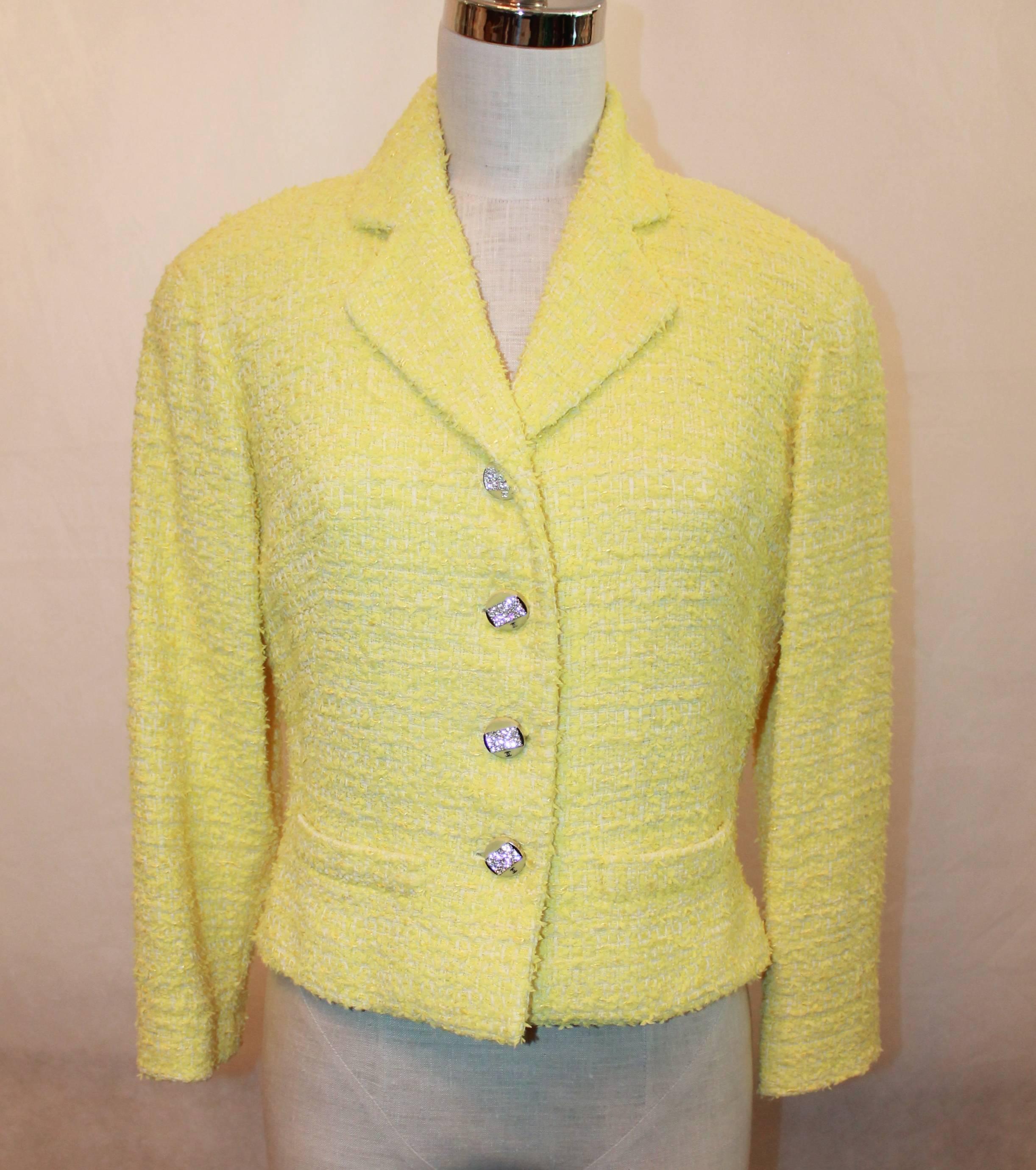 Chanel Yellow Tweed Jacket - 40.  This Chanel yellow tweed jacket is in excellent condition.  It has 4 yellow enamel and rhinestone Chanel buttons going down the center front.  It has two low front pockets.  It has a gold chain along the inside