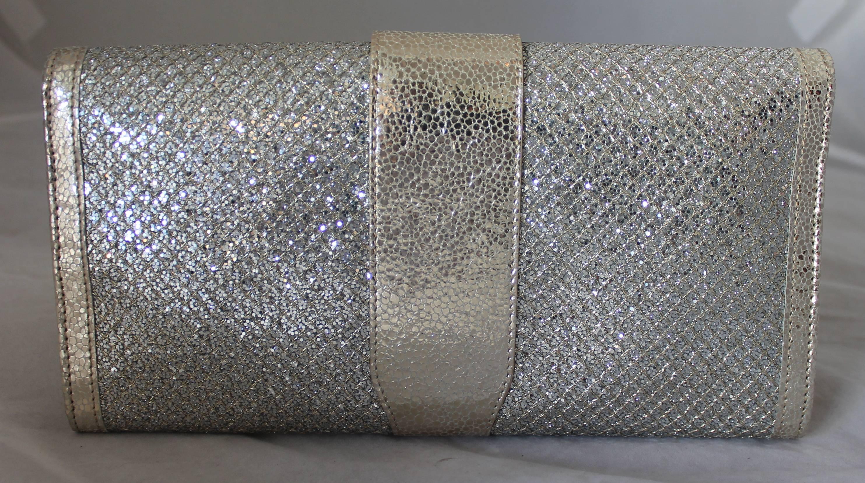 Jimmy Choo Silver & Gold Lame & Leather Sparkle Clutch - GHW.  This stunning clutch has two main compartments, separate zip compartments inside, and 12 credit card slits.  It has a beautiful sparkle lame w/ leather trim and interior.  It is in