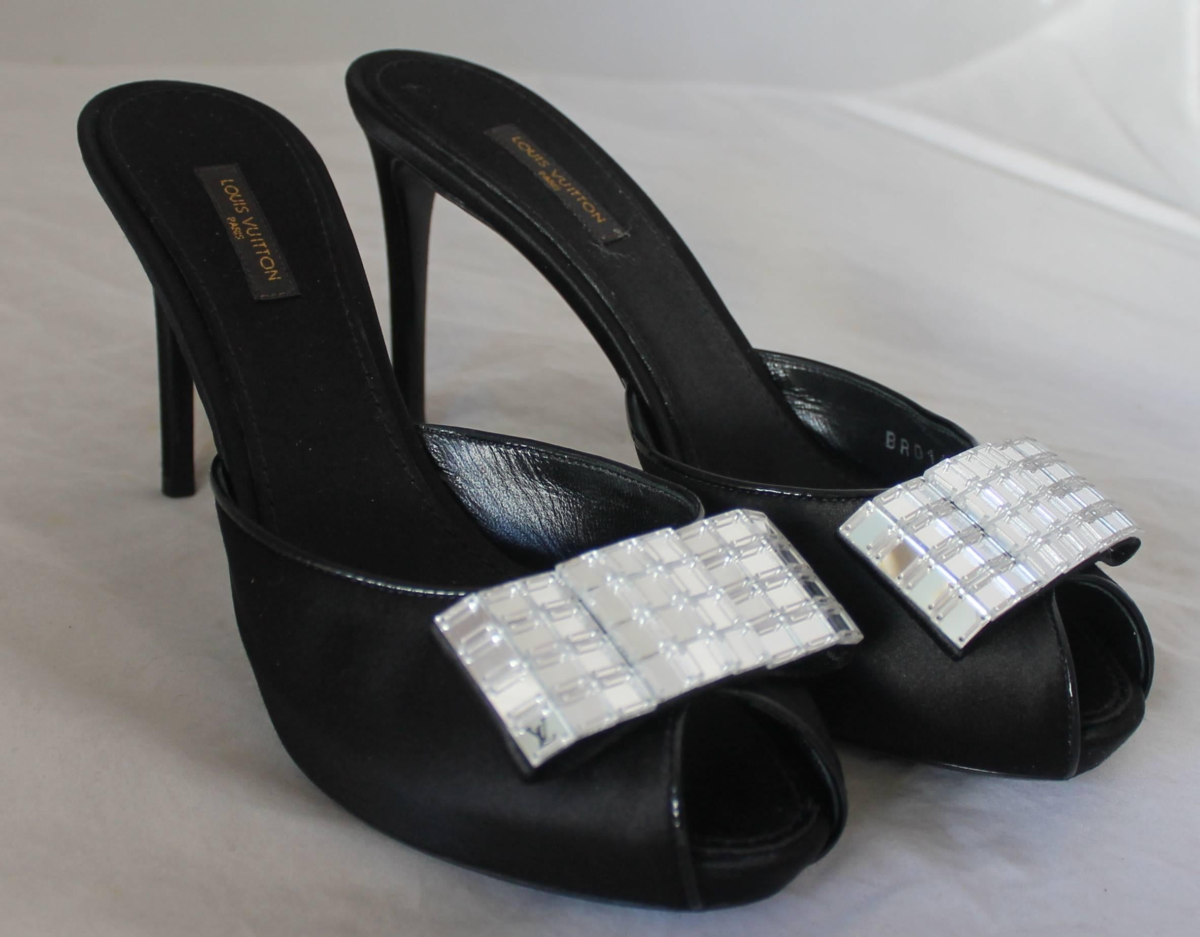 Louis Vuitton Black Satin Peep Toe Slide w/ Mirrored Bow - 40.  These beautiful shoes are in excellent condition.  They have a patent trim and a mirrored square beaded bow.

Measurements:
Heel: 4