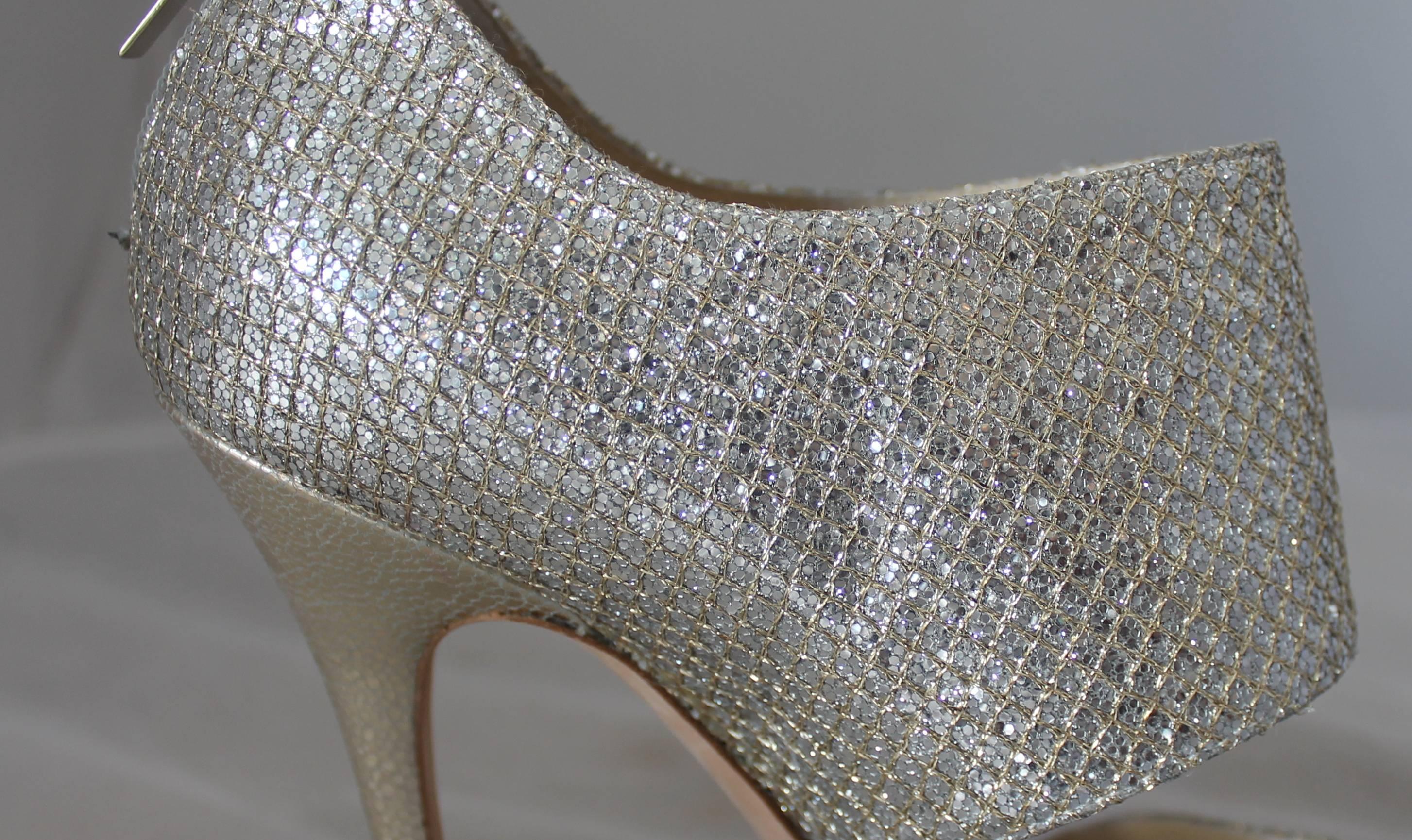 Jimmy Choo Silver and Gold Double Strap High Heel Bootie-Style Sandal - 39.5.  These stunning shoes have a silver and gold sparkle lame and leather material.  They have a back zip and a front platform.  They are barely worn and are in excellent