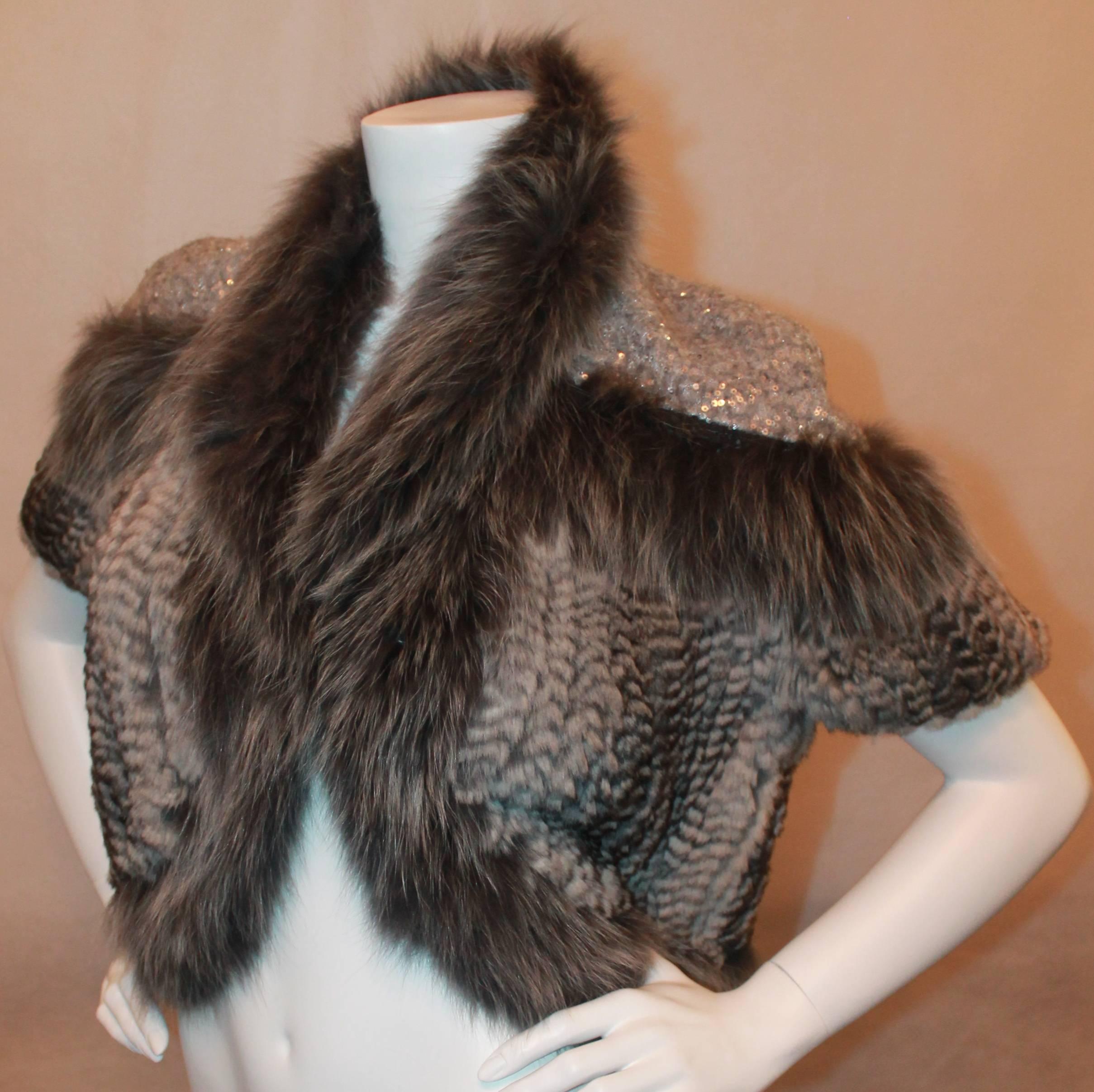 Hockley Grey Chinchilla and Fox Knitted Bolero w/ sequin shoulders-Size 44-NWT Retail price $5,200. This beautiful chinchilla fur jacket has short sleeve, fox trim and sequin detail on shoulders. It is new and never worn.

Measurements:
Bust