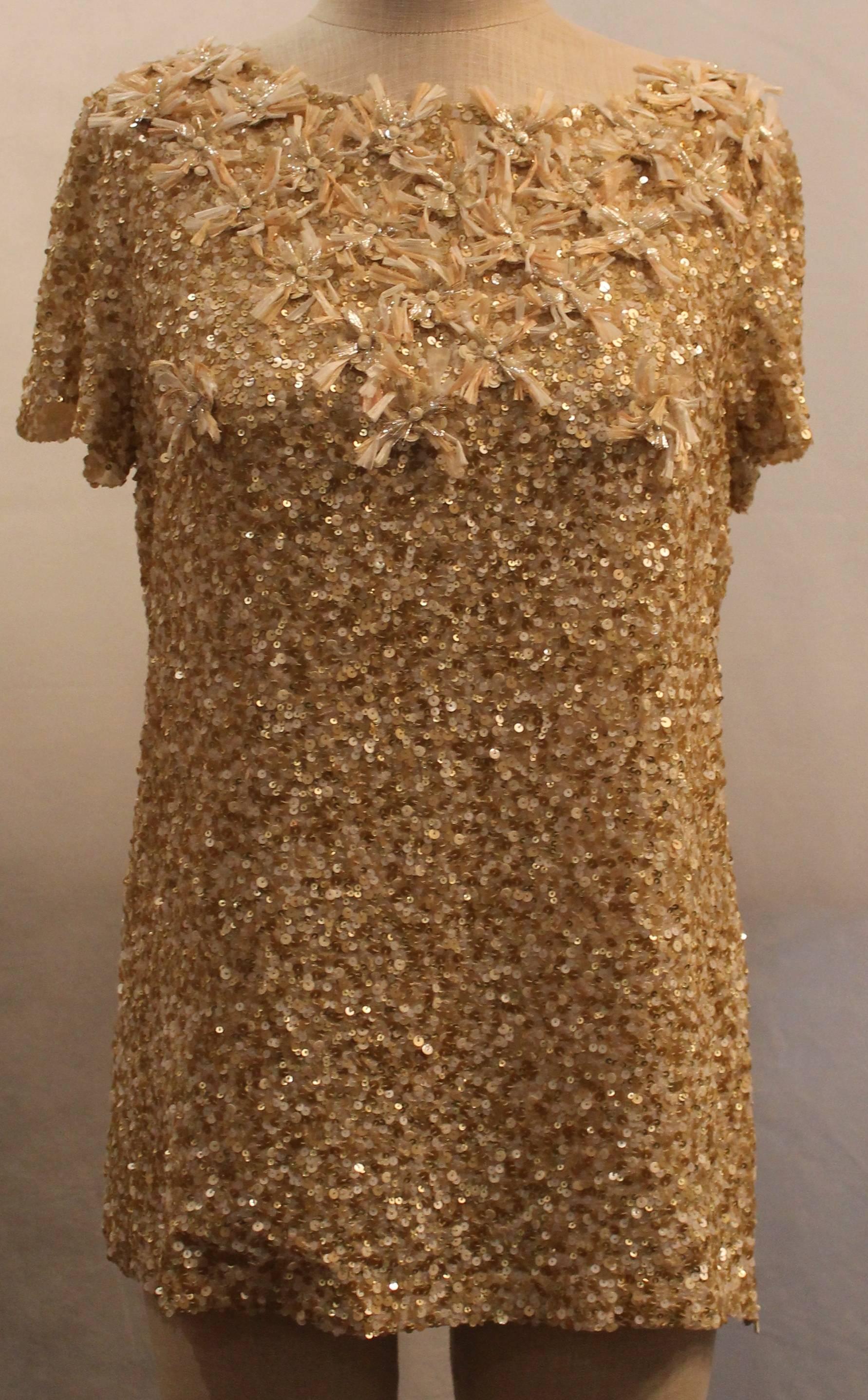 Oscar de la Renta Gold Sequin & Silk Top w/ Floral Fringe - 8  This shirt is in excellent condition. It has a floral fringe detail at the neckline and a side zipper.

Measurements:
Bust: 37