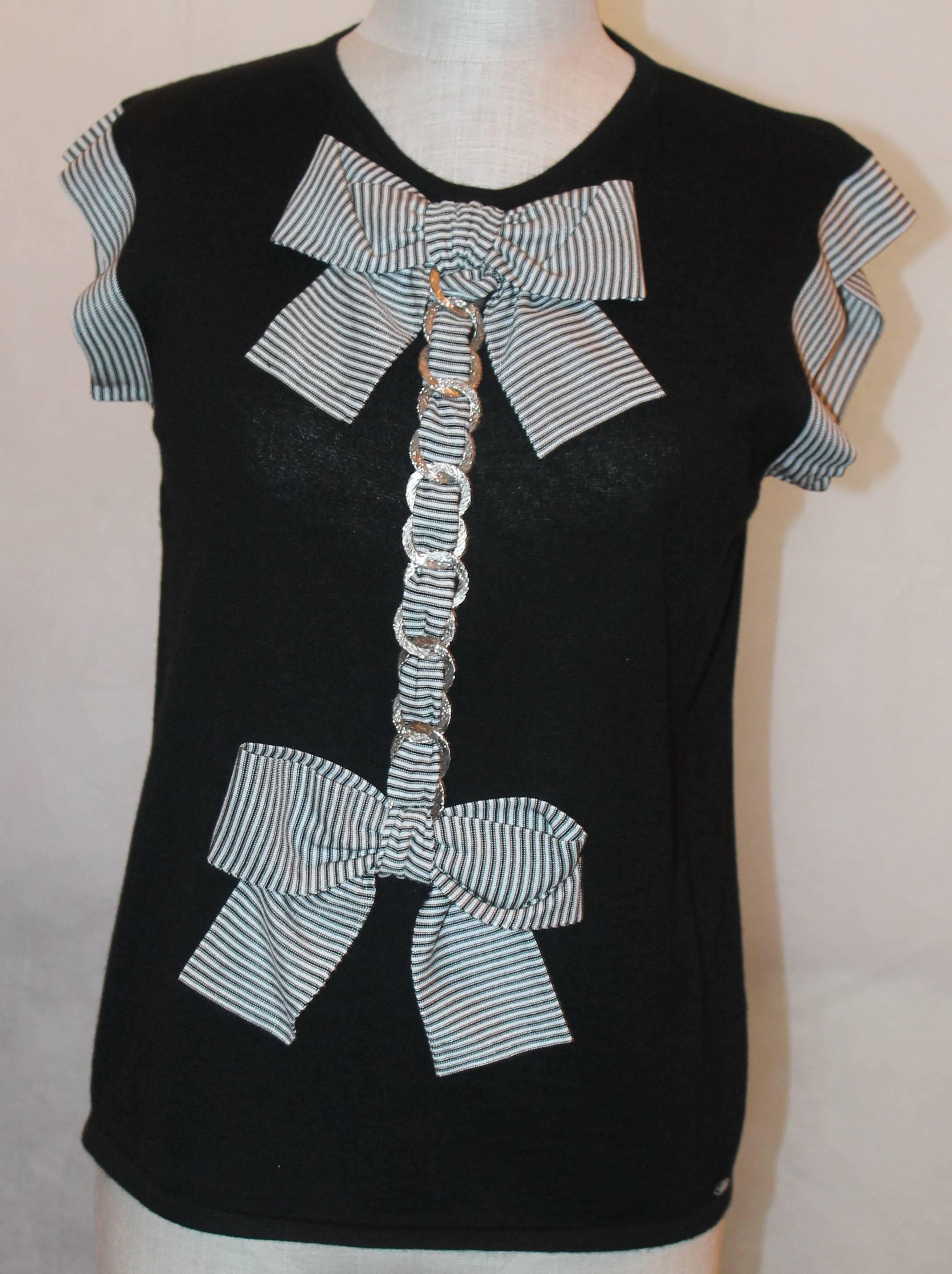 Chanel Black Cashmere & Silk Top w/ Bow & Chain Detail - 07P- Sz 40.  Top w/ black and white striped trim on shoulders and on bows down the center.  Its front detail is intertwined with a silver chain link.  It has a Chanel emblem on the bottom left