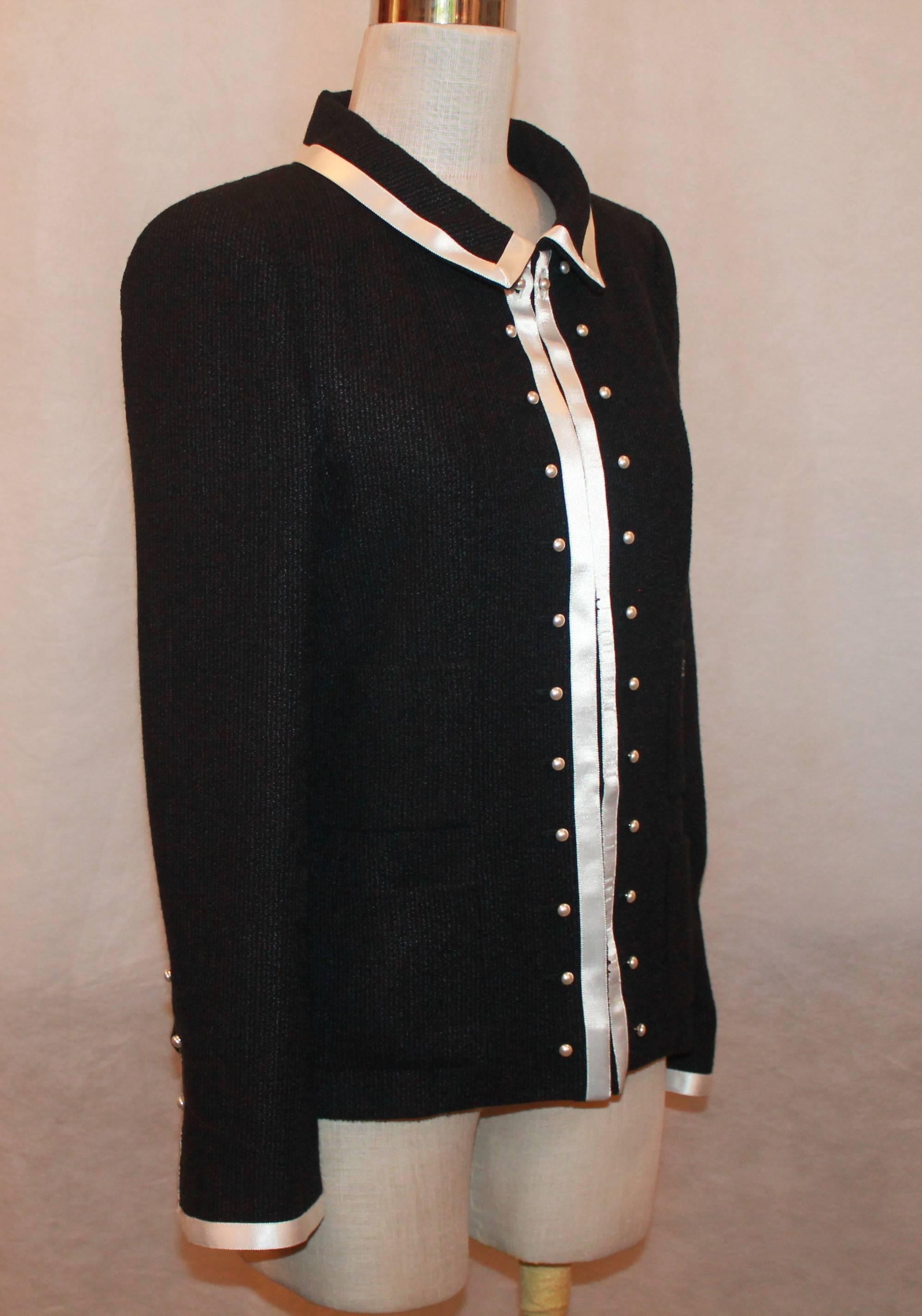 Chanel Black 4-Pocket Jacket with White Ribbon Trim and Pearls - 40 This jacket is in excellent condition. The fabric consists of 86% wool and 14 % silk. The black and white trim is also found on the cuffs of the sleeves. This jacket has snaps in