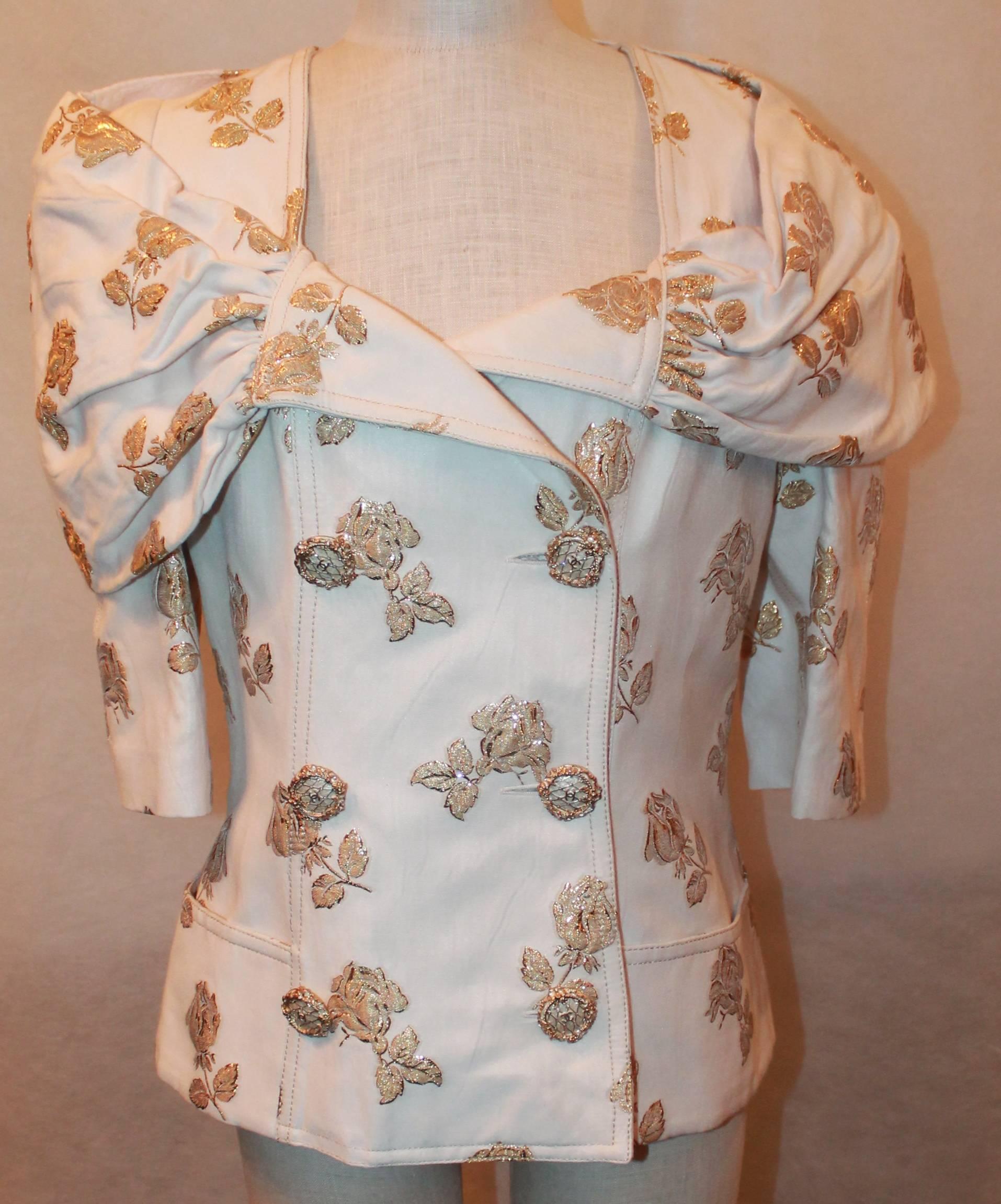 Chanel 3/4 Sleeve Ruched Portrait Collar Jacket with Floral Print - 44
This Silk Brocade Chanel Jacket is NWT retail $8,735. It is double breasted with two front pockets. These ornate buttons have white enamel and a gold vine design with