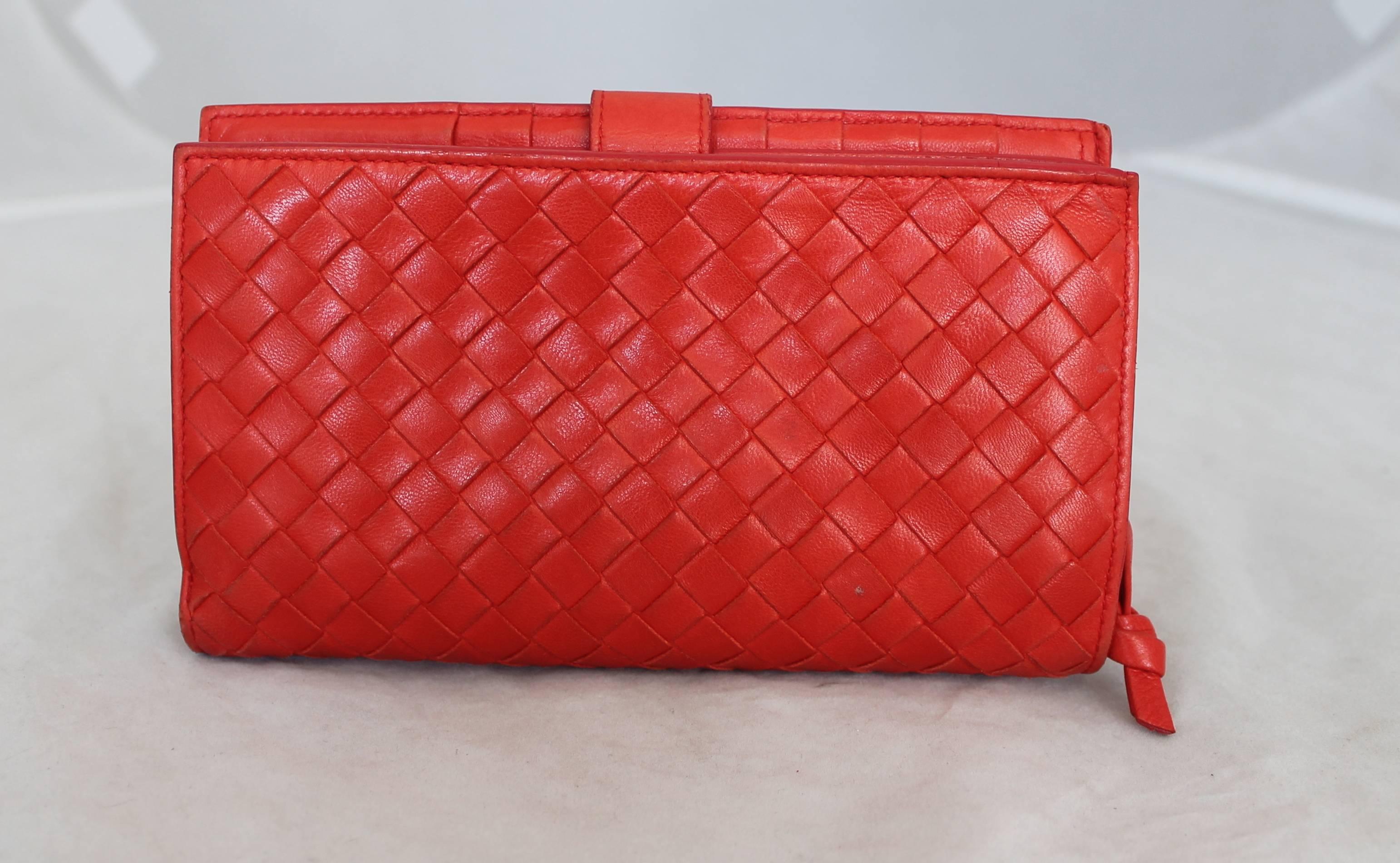 Bottega Veneta Red Woven Leather Wallet.  This wallet is in fair condition; it has wear on the leather and a pen mark on the inside.  It has beautiful, smooth leather woven detail.  The interior contains 8 credit card slits, 3 slit compartments, and