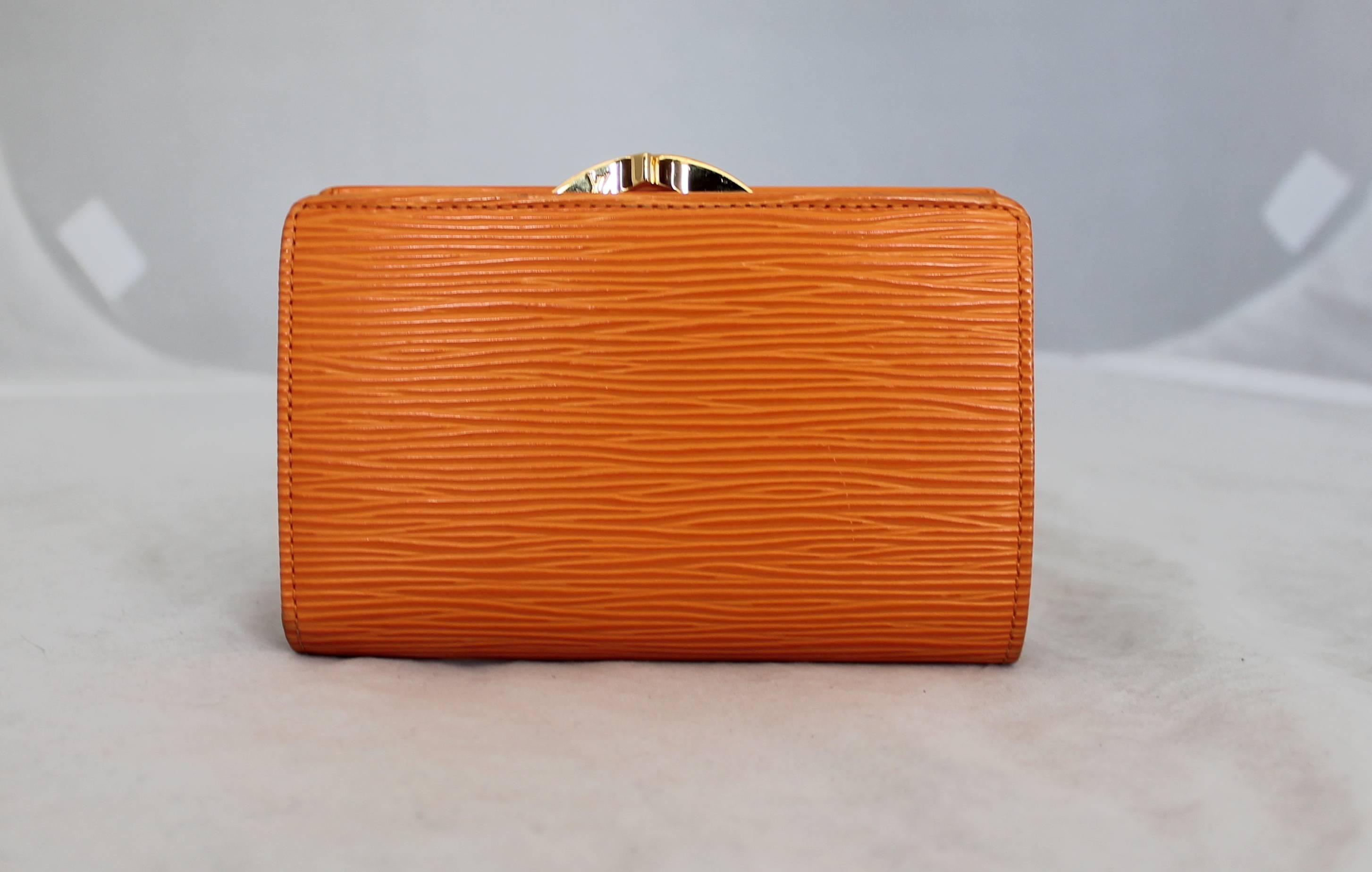 Louis Vuitton Orange Wallet. This Louis Vuitton epileather wallet is in excellent condition. It has a clasp at top and also has a coin purse with an old fashion clasp and card holder. It is from 2008. 

Wallet Dimensions:

Height- 3.5