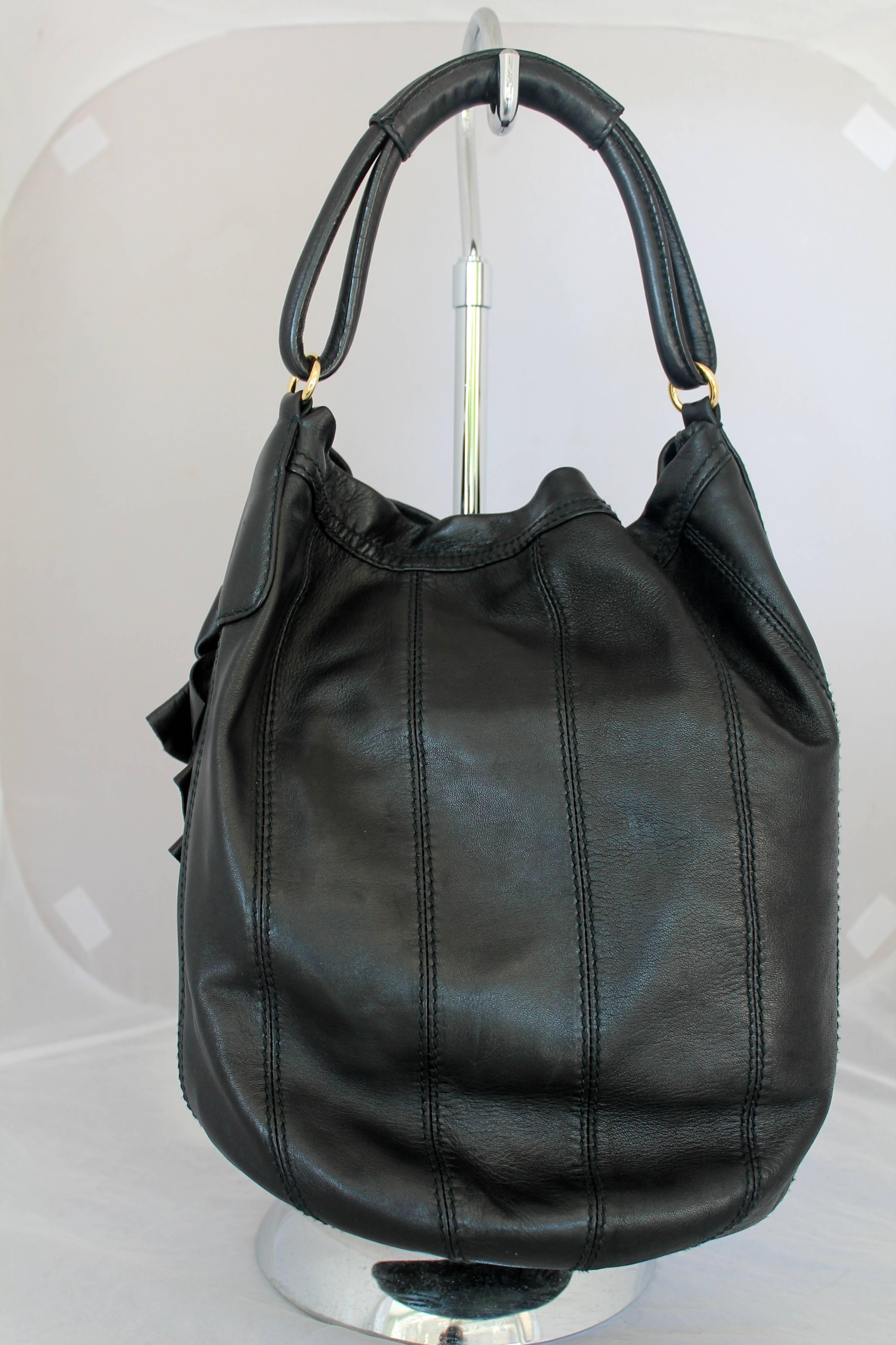 Valentino Black Leather Ruched Flower Shoulder Bag GHW.  This shoulder bag is in excellent condition.  It is hobo style.  It has ruched flower details on the front side.

Measurements:
Height: 13.5