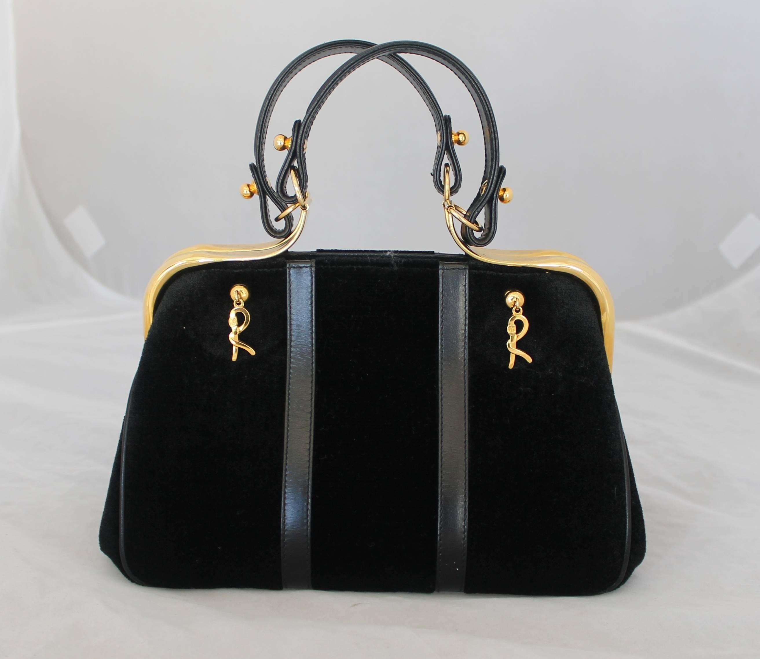 Roberto Di Camerino Black Cut Velvet Bag w/ Leather Detail & Front Design
This bag is in excellent vintage condition. It also has leather lining and includes gold hardware along the top of the bag and on the hanging