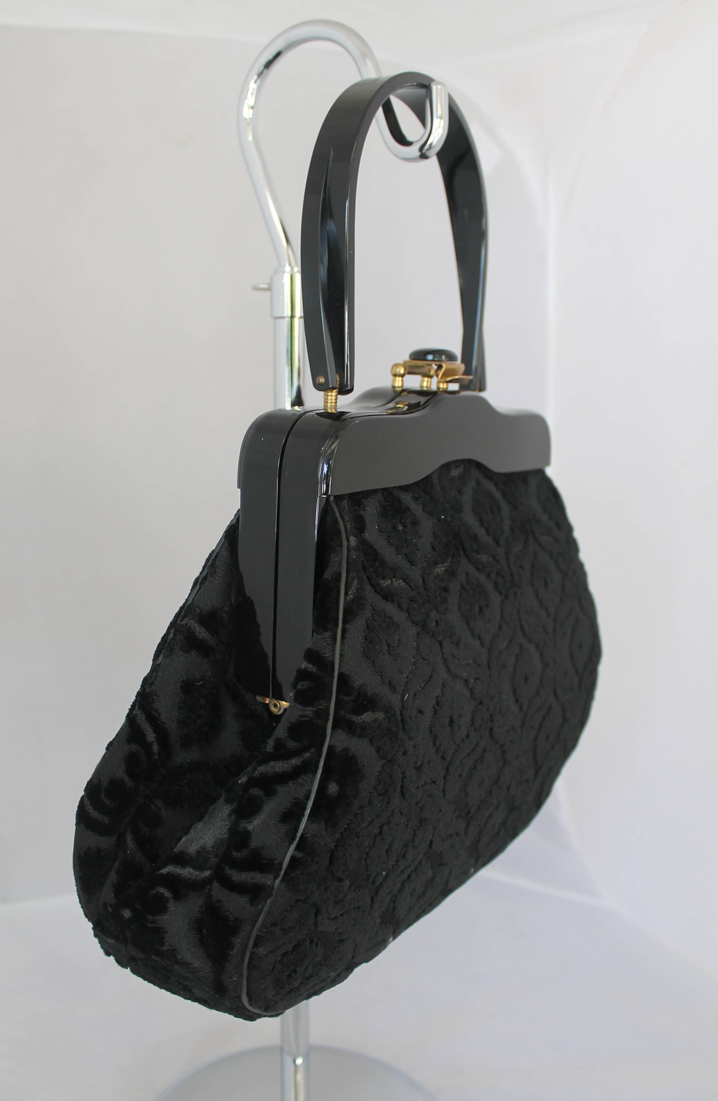 1950's Rialto Vintage Black Handbag w/ Cut Velvet Design & Black Lucite Handle. This bag is in very good vintage condition. It has black satin lining. However it has a very minor scratch on the Lucite top handle.

Measurements:
Height: