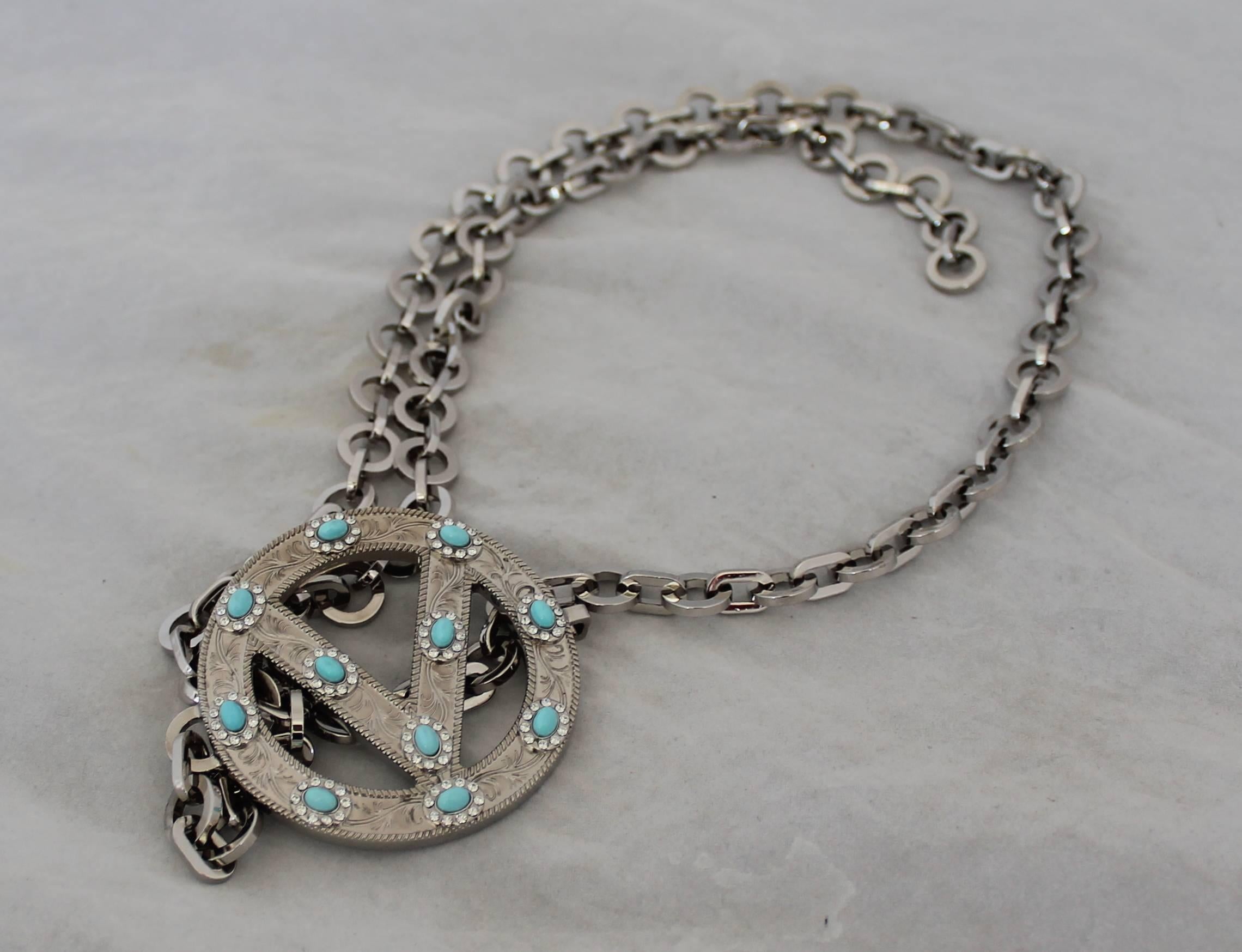 Valentino Thin Silver Single Chain Belt w/ Logo Buckle This belt is in excellent condition. It has an etched design w/ turquoise and rhinestones.

Measurements:
Buckle:
Length: 2.5