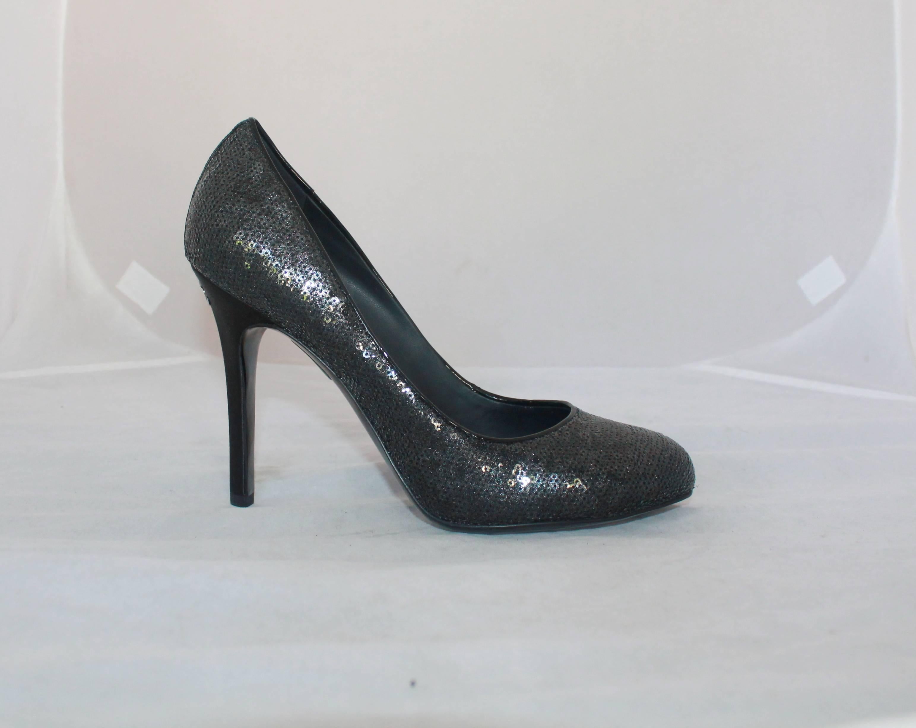 Chanel Black Sequin Pumps w/ Quilted Interior - Never Worn - 40.  These exquisite pumps are absolutely beautiful with the entire exterior covered in black sequins.  They have a silver "CC" on the heel.  They are in perfect condition as