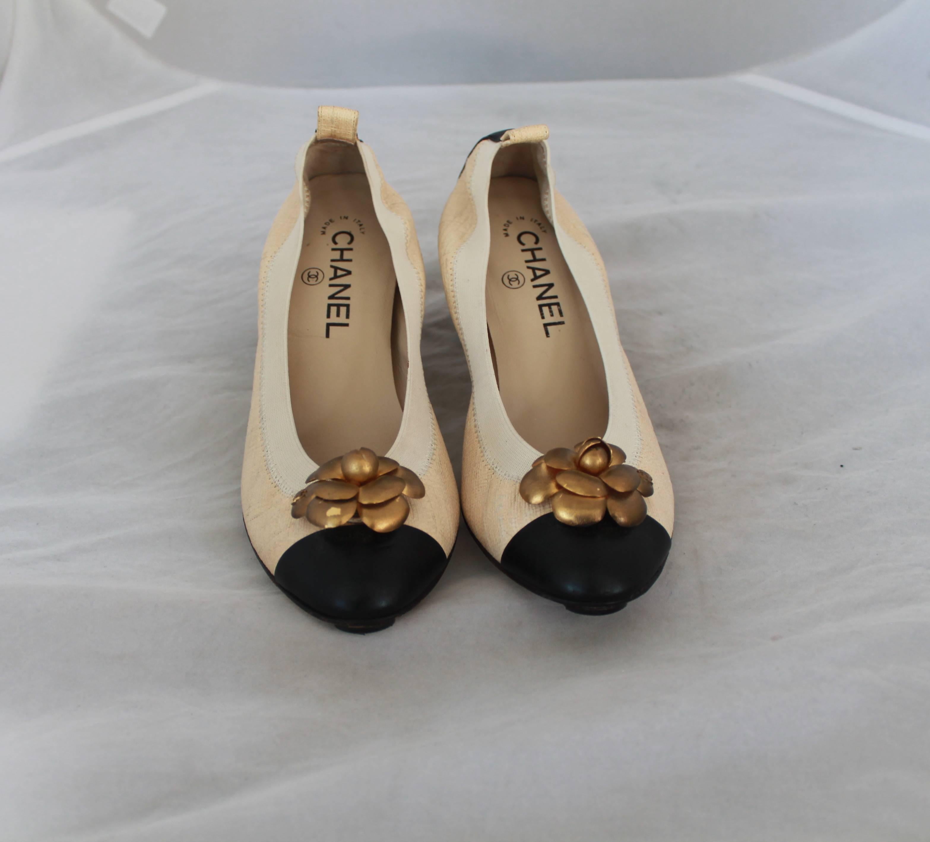 Chanel Beige Textured  Leather Scrunch Pumps w/ Black Toe & Gold Camellia - 37.  These scrunch pumps are made of leather textured with a linen look.  They have a black leather toe and a gold leather Camellia with 