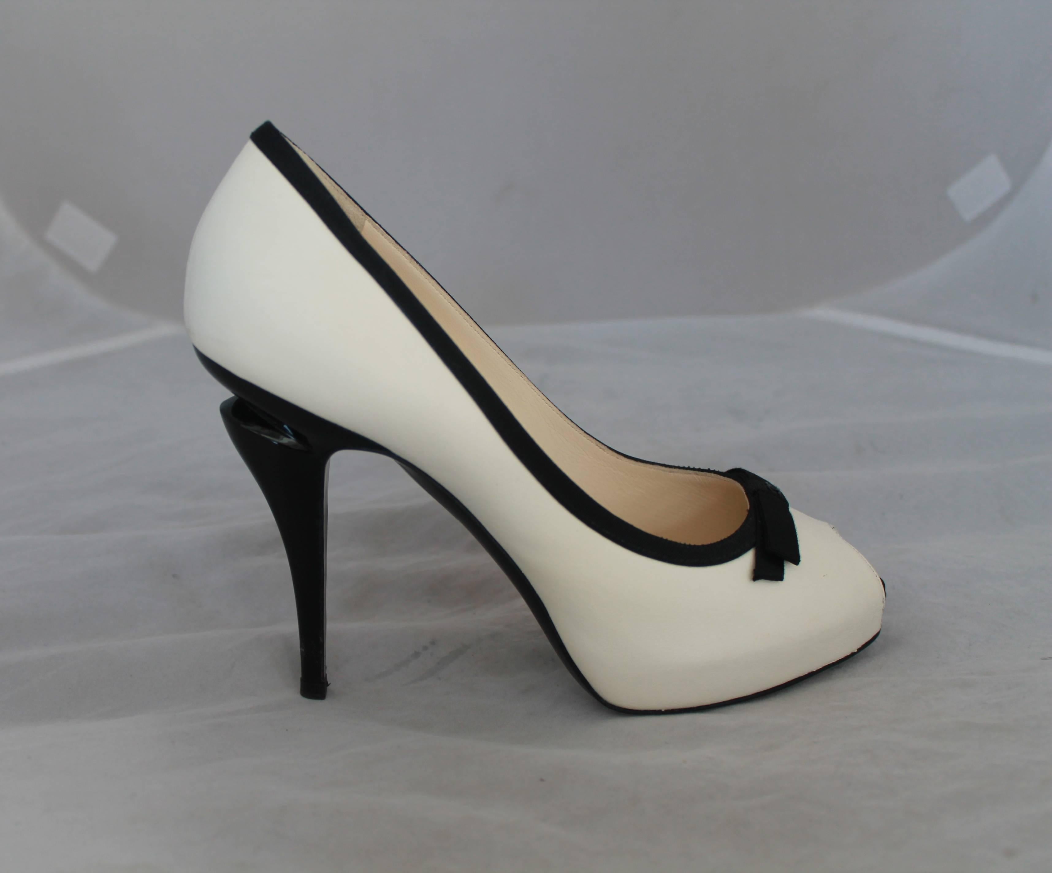 Chanel Ivory & Black Lambskin Peep Toe Pumps w/ Black Ribbon Trim - 40.  These peep-toe pumps have a black ribbon trim with a front 