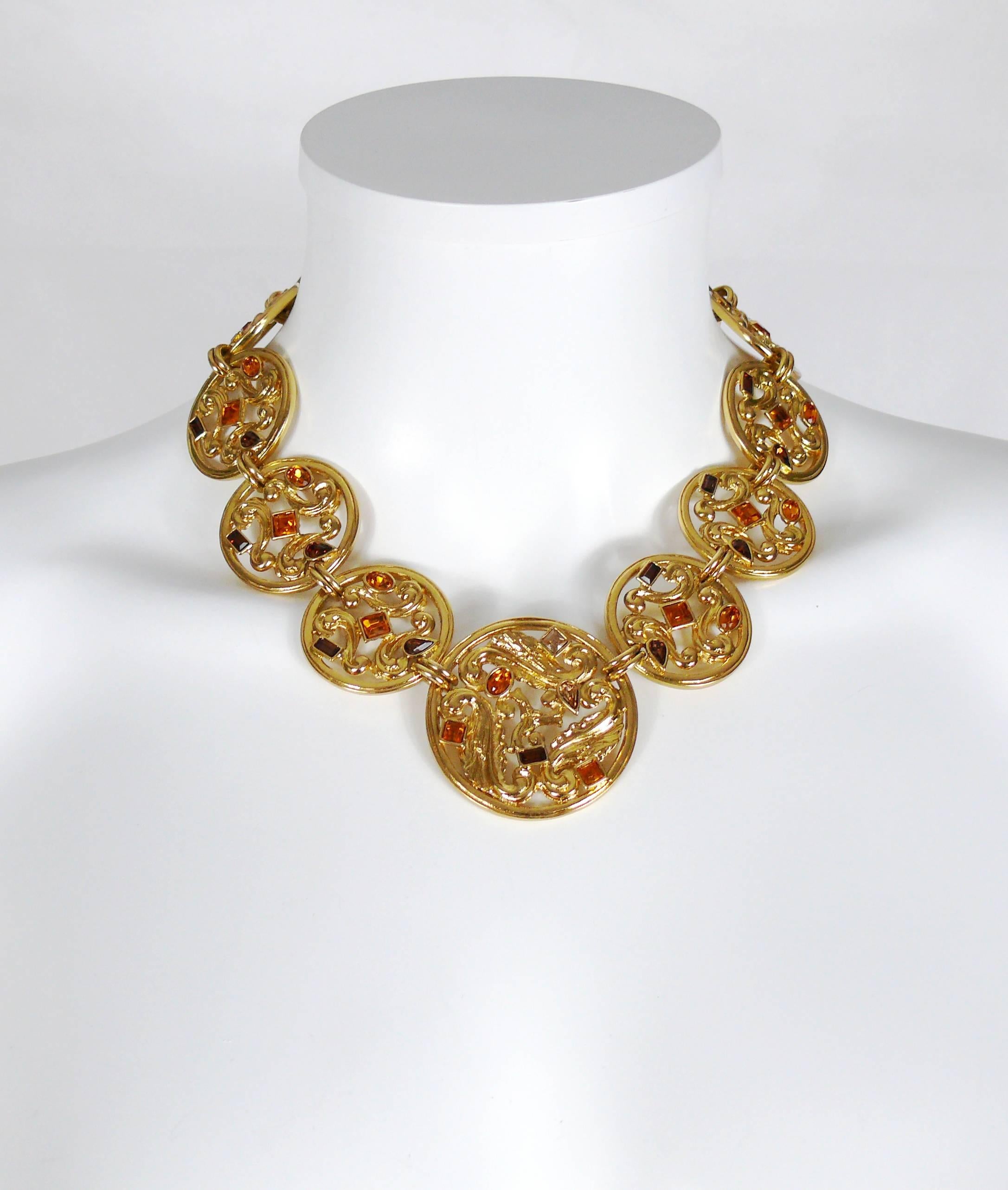 YVES SAINT LAURENT vintage gold toned medallion necklace featuring an openwork scroll design with crystal embellishement.

Lobster clasp closure with extension chain.

Embossed YSL Made in France on the clasp.

Indicative measurements : max. length