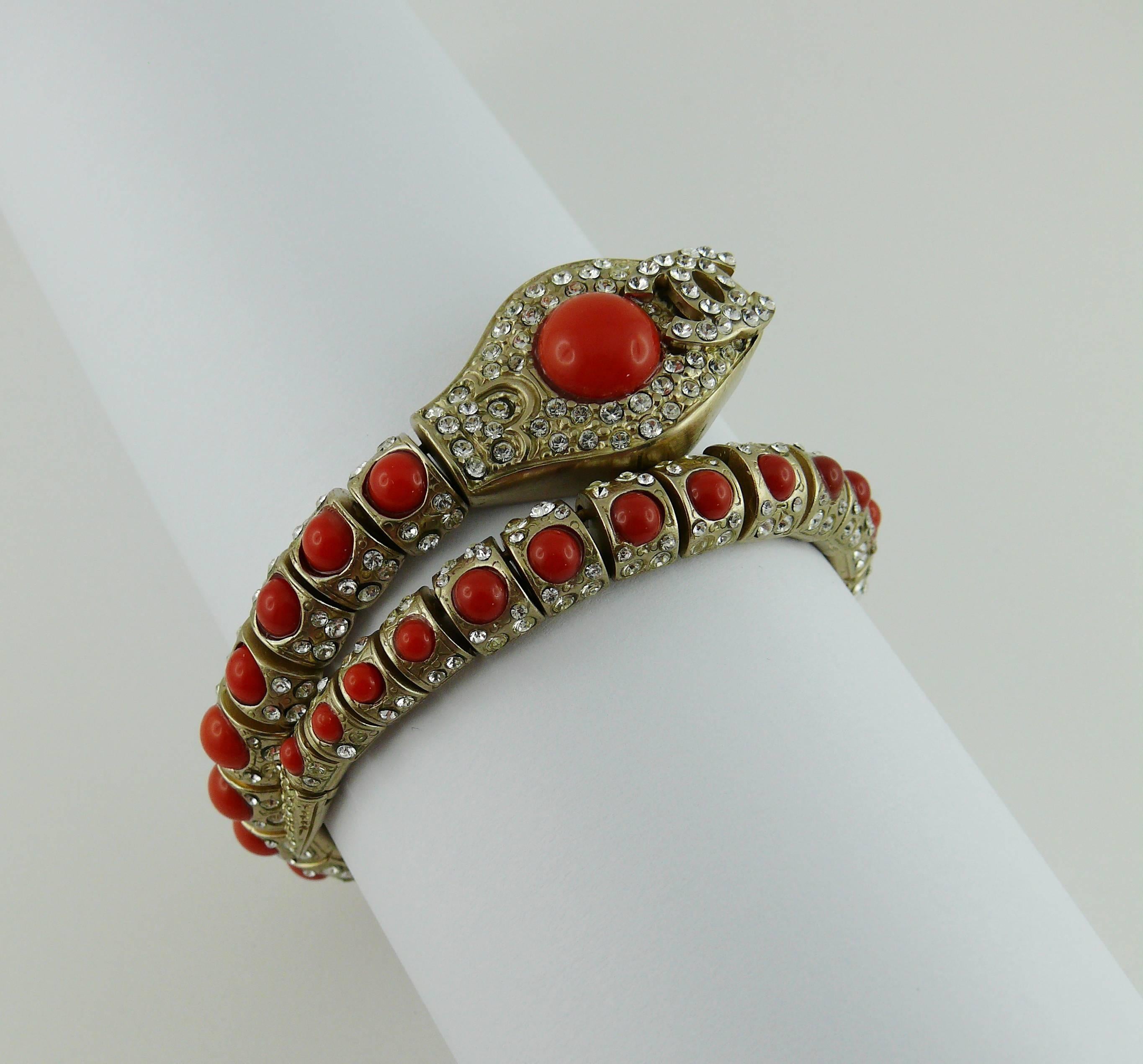 CHANEL gorgeous articulated snake bracelet featuring faux coral stones, clear crystals and interlocking CC logo.

Brushed metal with pale gilt.

Marked CHANEL 08 Made in Italy.

Indicative measurements : inner circumference unstretched approx. 17.29