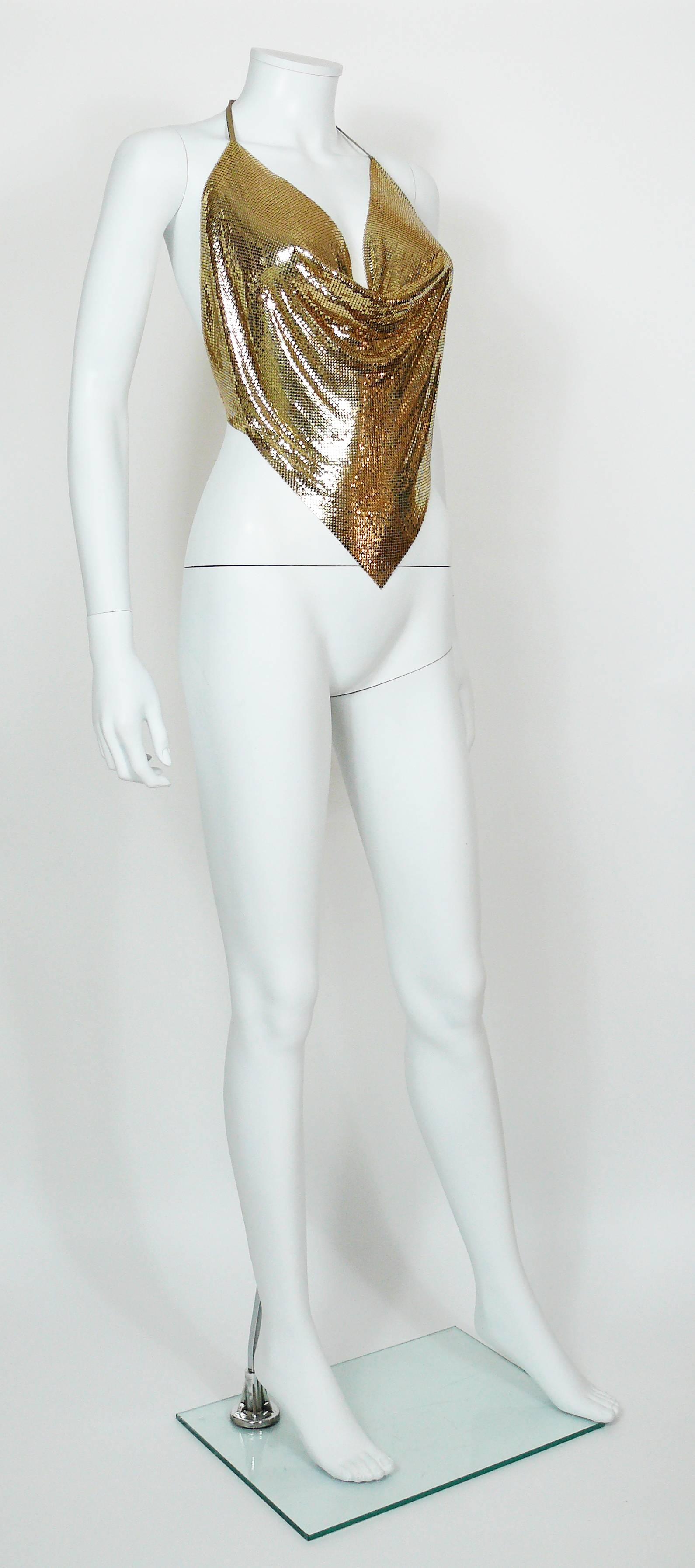 DIAMANT NOIR Paris vintage 1980s disco gold tone metal mesh halter top with gold leather detailing.

Slip on.
Ties in the back.

Label reads DIAMANT NOIR.

Composition and size labels are missing.
Photographied on a EUR 36 size mannequin (XS).
We