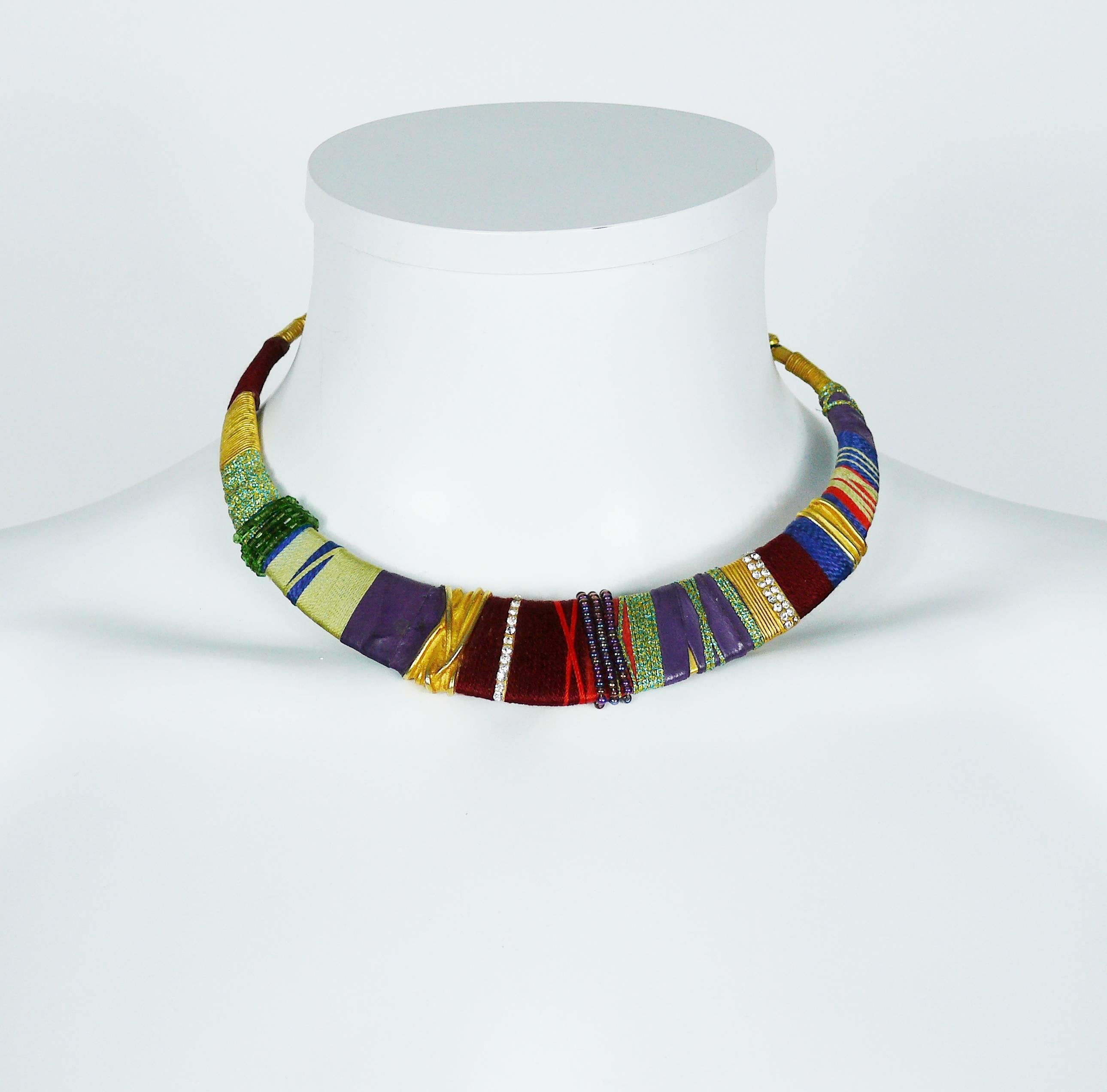 CHRISTIAN LACROIX vintage Masai inspired gold tone rigid choker necklace embellished with multicolored pearls, fabrics, purple leather and clear crystals.

Hook clasp.

Marked CHRISTIAN LACROIX CL Made in France.

Indicative measurements :