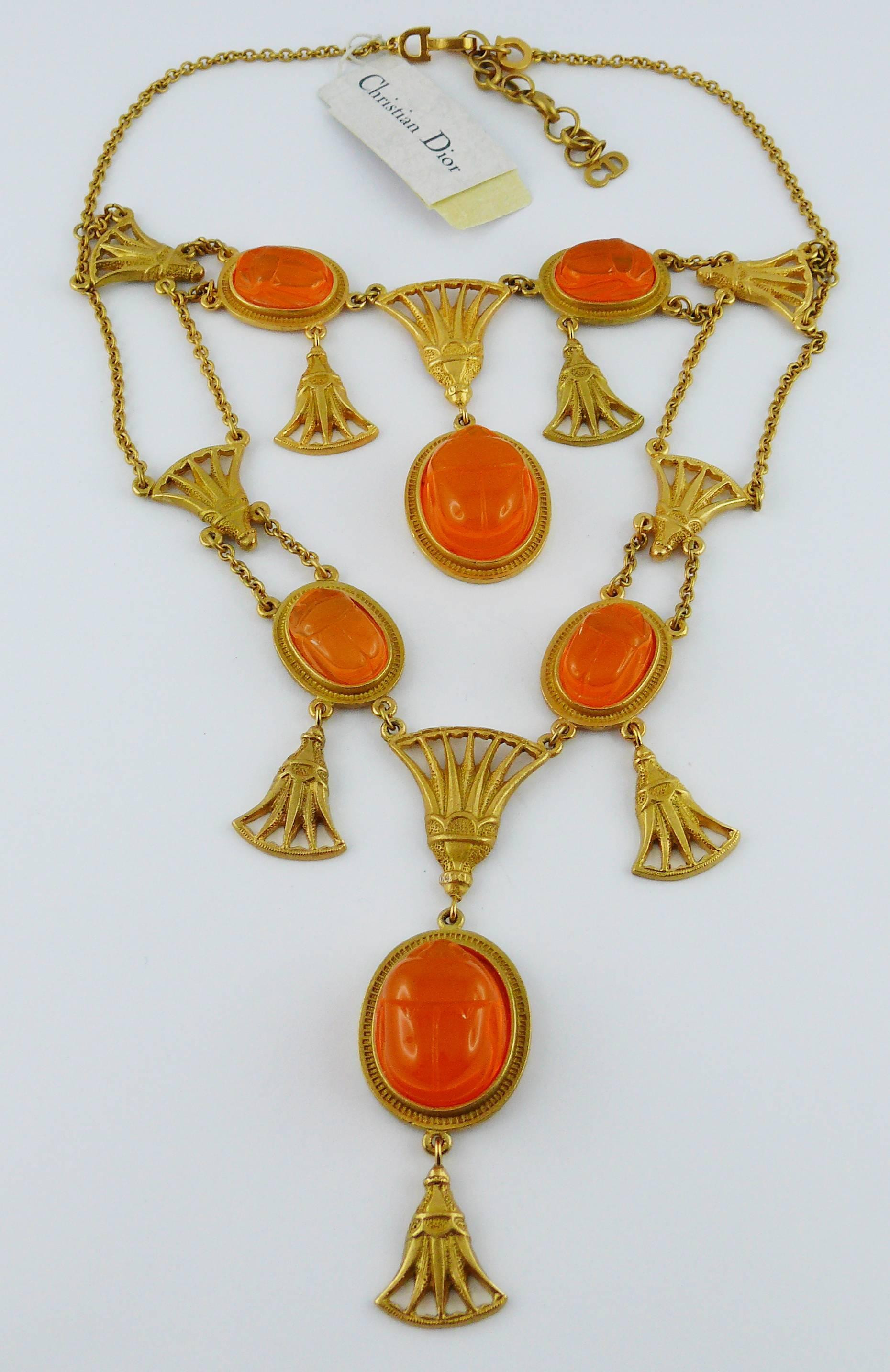 CHRSITIAN DIOR by JOHN GALLIANO Egyptian revival necklace featuring antique ornaments and six lucite scarabs in a matte gold tone setting.

The scarabs are an irridescent orange/gold which changes in different light and upon movement.

Spring/Summer