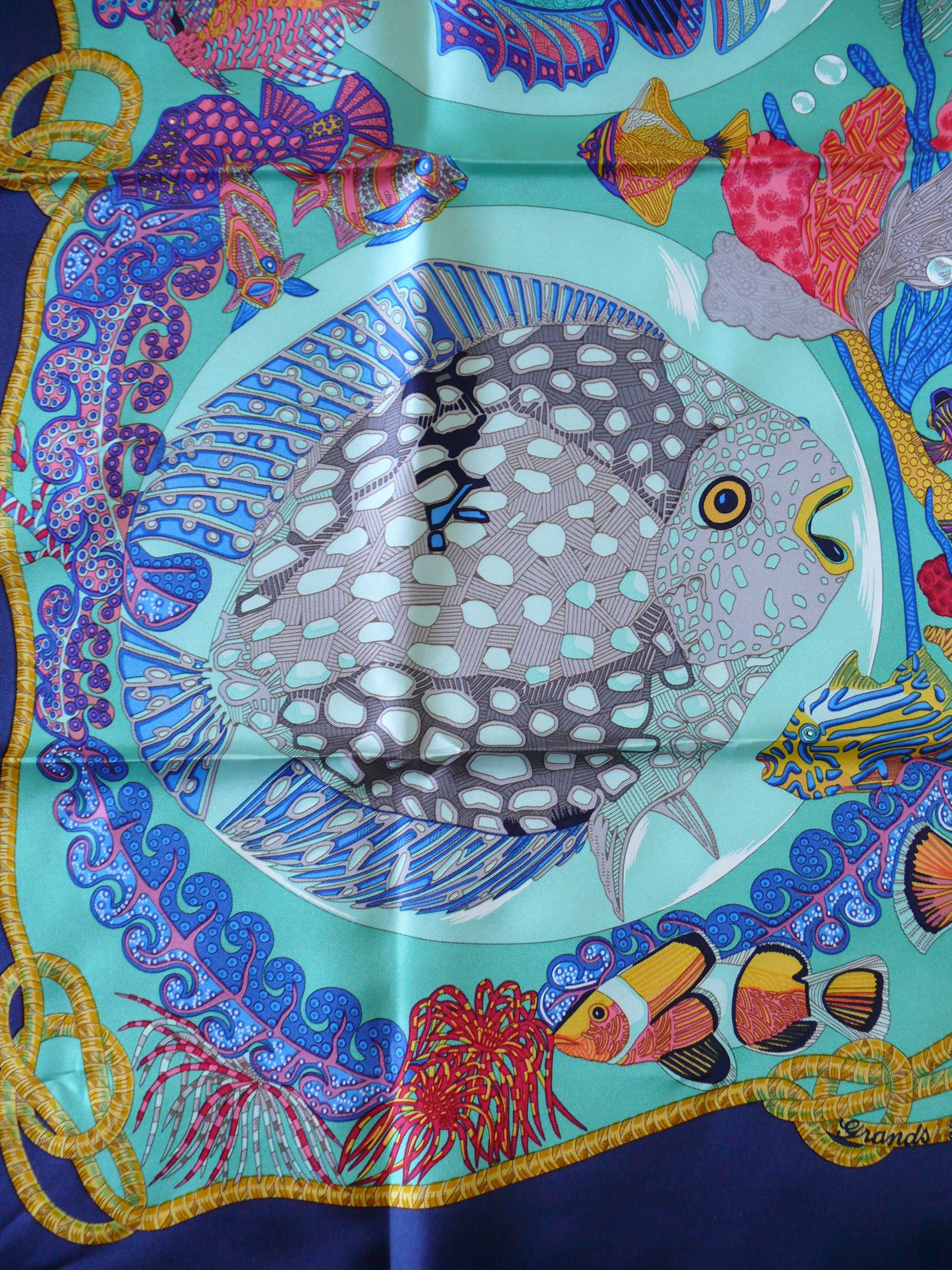 HERMES vintage 1992 hard to find silk carre scarf "Grands Fonds" featuring a gorgeous opulent and vibrant sea-life design. Blue borders.

Designed by ANNIE FAIVRE.

This scarf features :
- Hand rolled borders.
- Plump hems.
- 100 % silk.
-