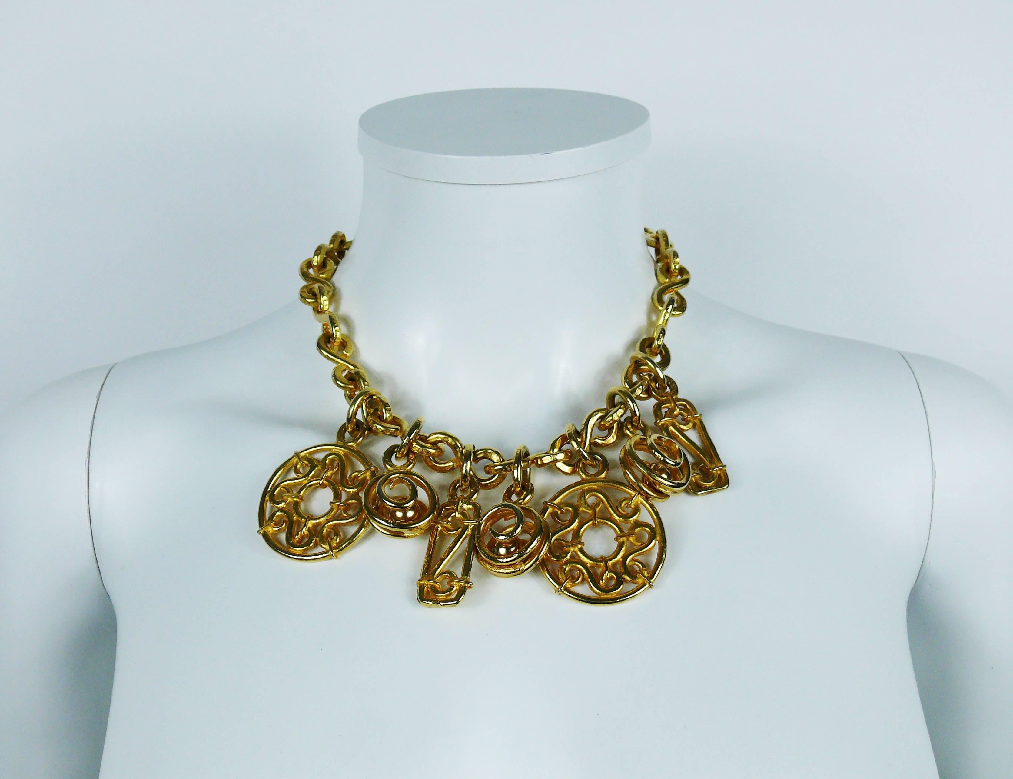 CELINE vintage gold toned necklace featuring a heavy hammered S-link chain holding seven charms including discs, rectangles and encaged balls with a gorgeous arabesque design.

T-bar and toggle closure.

Marked CELINE Paris Made in Italy