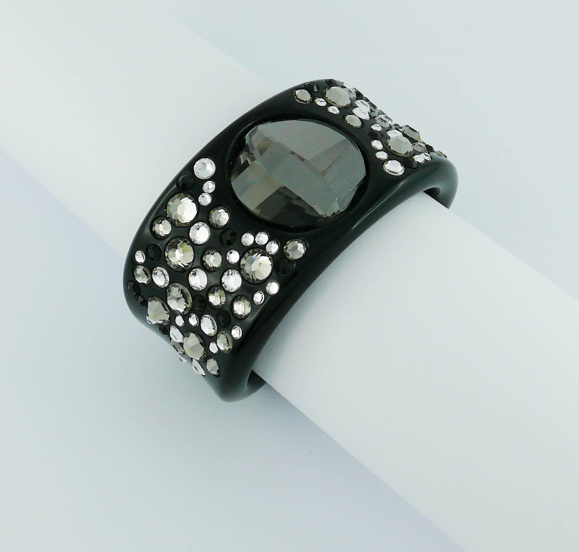 CHRISTIAN DIOR gorgeous black lucite cuff bracelet embellished with clear, "black diamond" and jet SWAROVSKI crystals.

Metal D (DIOR) on both ends of the cuff.

Indicative measurements : inner length 6.2 cm (2.44 inches) / width approx.