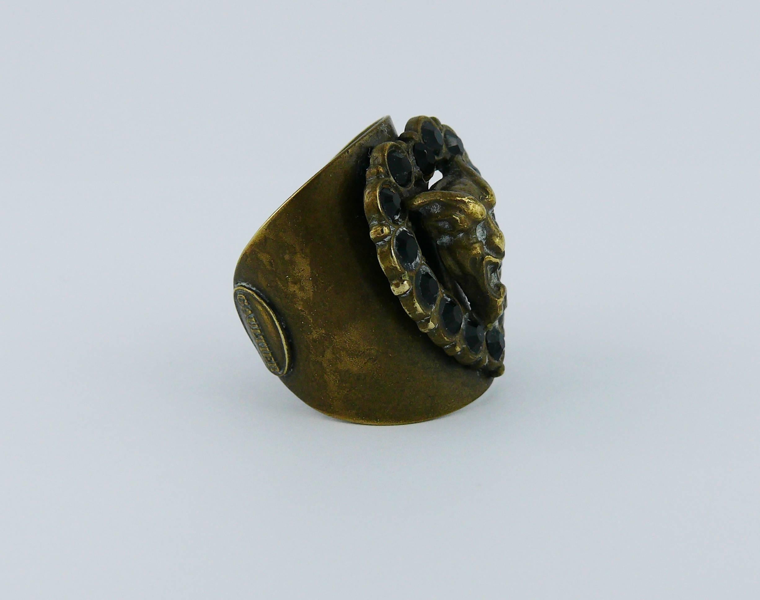 JEAN PAUL GAULTIER vintage demon ring embellished with jet crystals in a bronze with antique patina setting.

Marked GAULTIER.

Indicative measurements : inner circumference approx. 5.65 cm (2.22 inches) / length approx. 2.8 cm (1.10