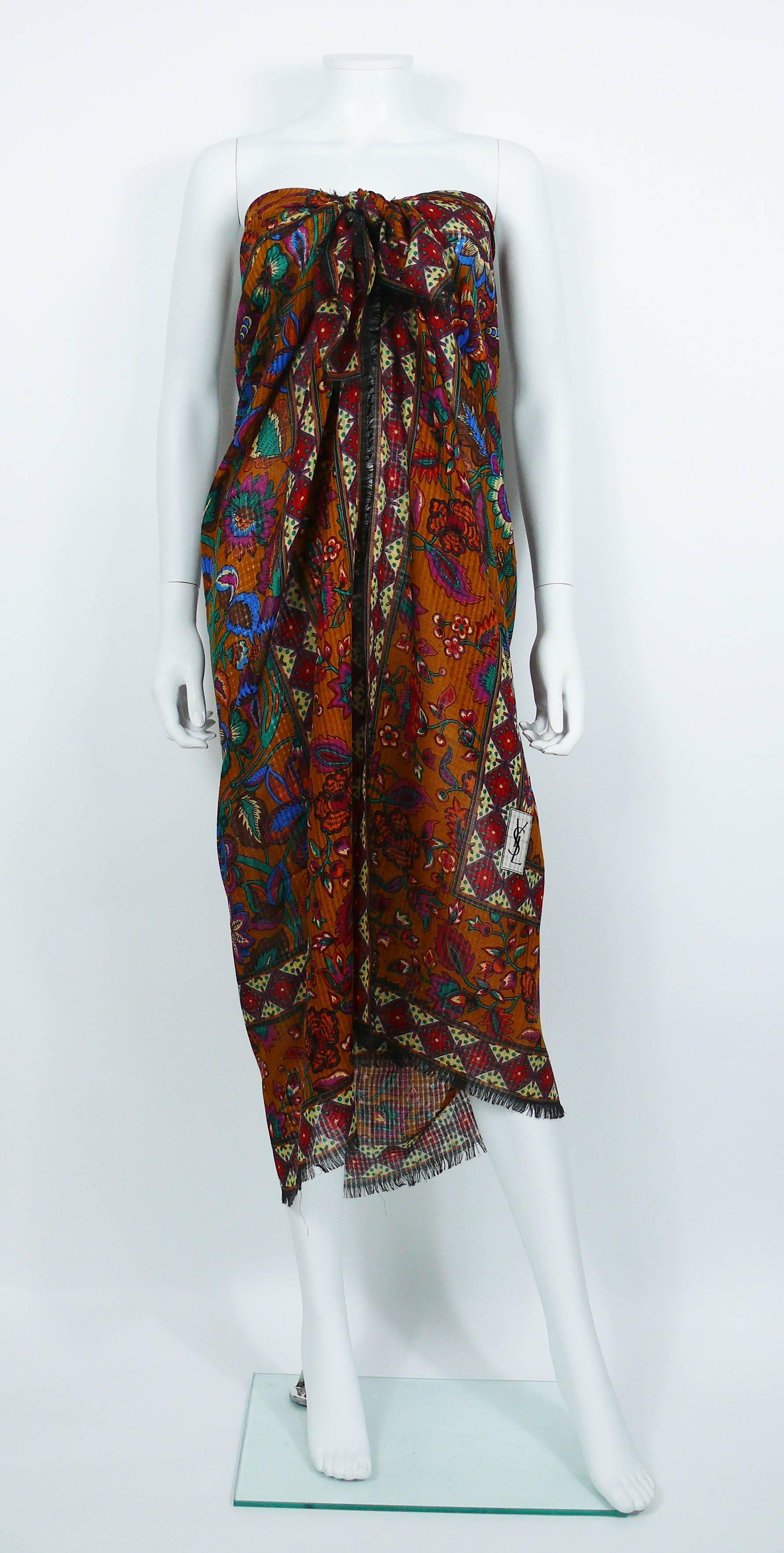 YVES SAINT LAURENT vintage 1970s peasant shawl featuring a multicolored floral design on a saffron color background. Fringed borders.

Printed YSL.
No labels attached.

Indicative measurements : 132 cm (51.97 inches) x 132 cm (51.97