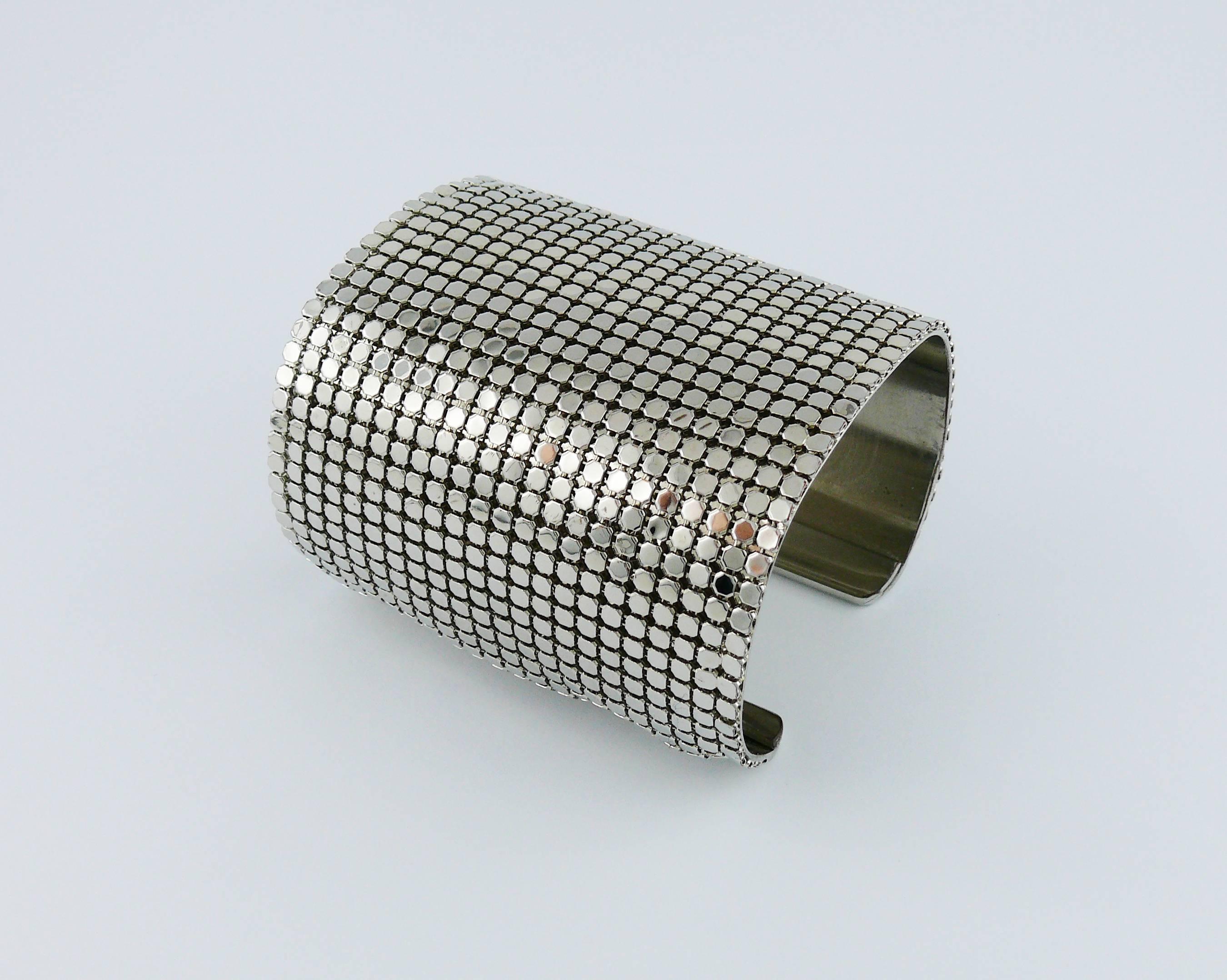 PACO RABANNE vintage silver toned wide Disco bracelet cuff featuring a chainmail grid design application on a rigid base.

Embossed PACO RABANNE.

Indicative measurements : inner circumference approx. 18.85 cm (7.42 inches) / length approx. 6.9 cm