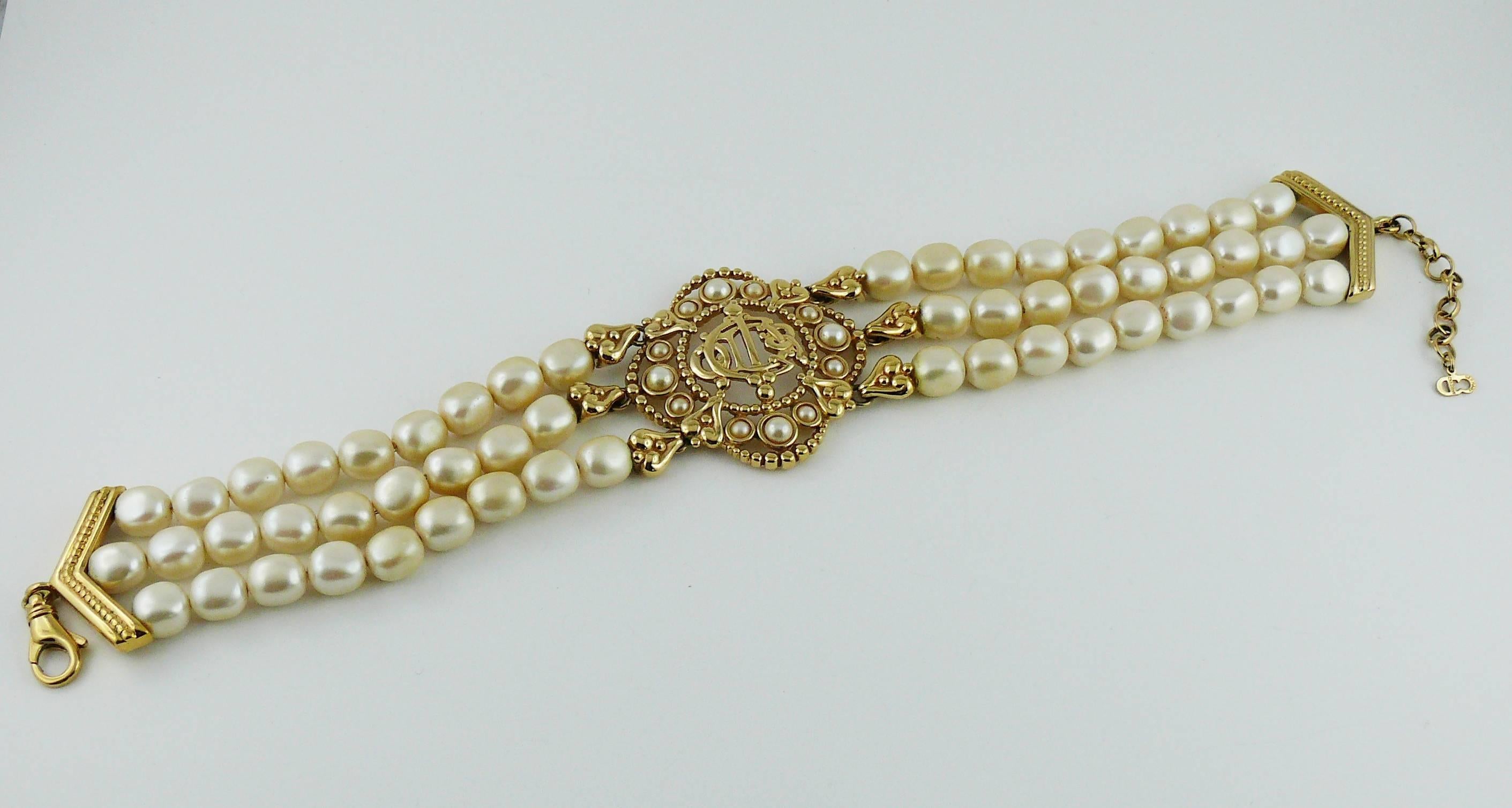 CHRISTIAN DIOR vintage gold toned choker necklace featuring three strands of large faux pearls and an openwork medallion at center with DIOR logo.

Lobster clasp closure.
Extension chain.

Embossed CHR. DIOR Germany.

Indicative measurements : max.