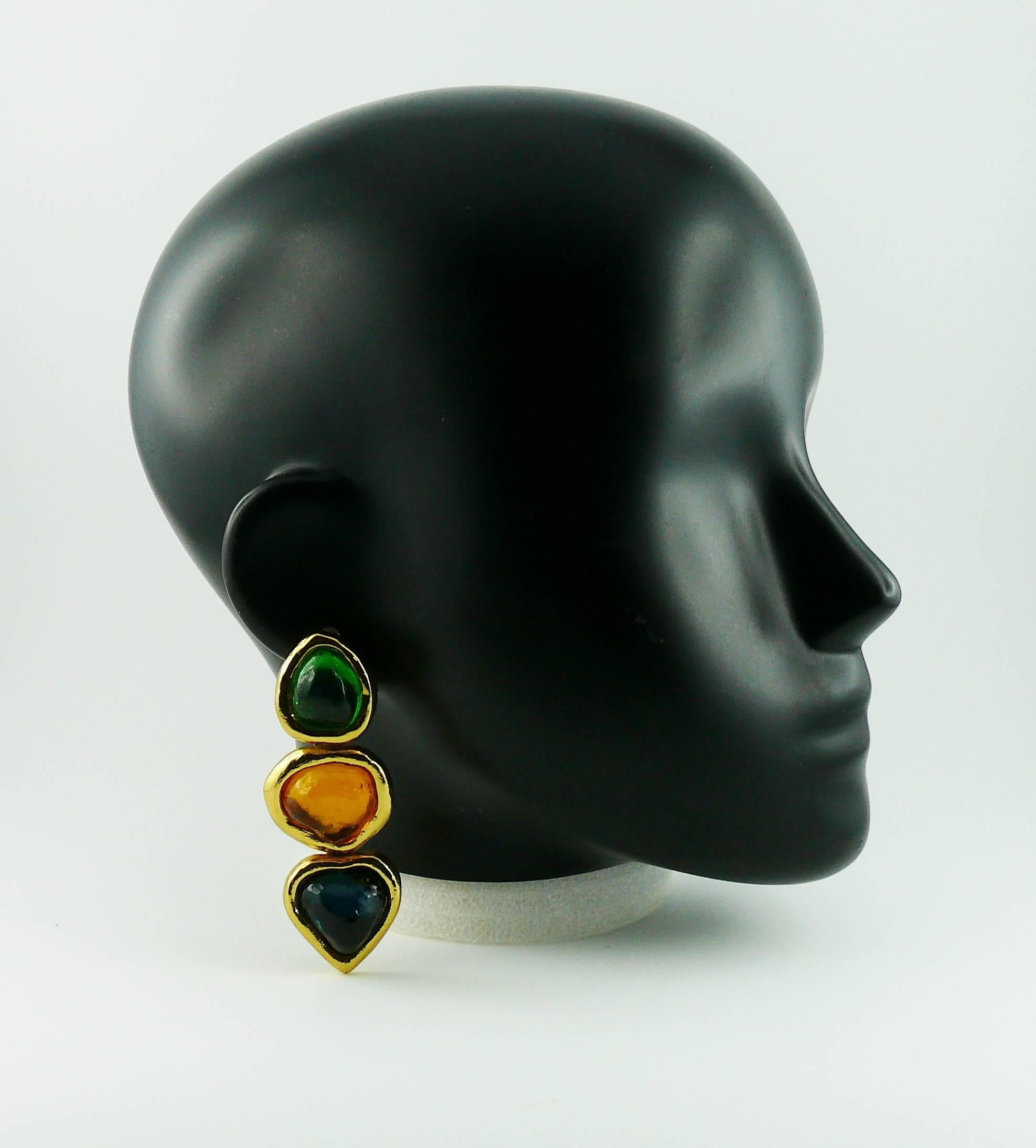 YVES SAINT LAURENT multicoloured resin dangling earrings (clip on).

These earrings feature 3 irregular shaped resin cabochon (green, orange and deep blue) in a gold toned setting.

Created by French parurier ROBERT GOOSSENS.

Embossed YSL Made in