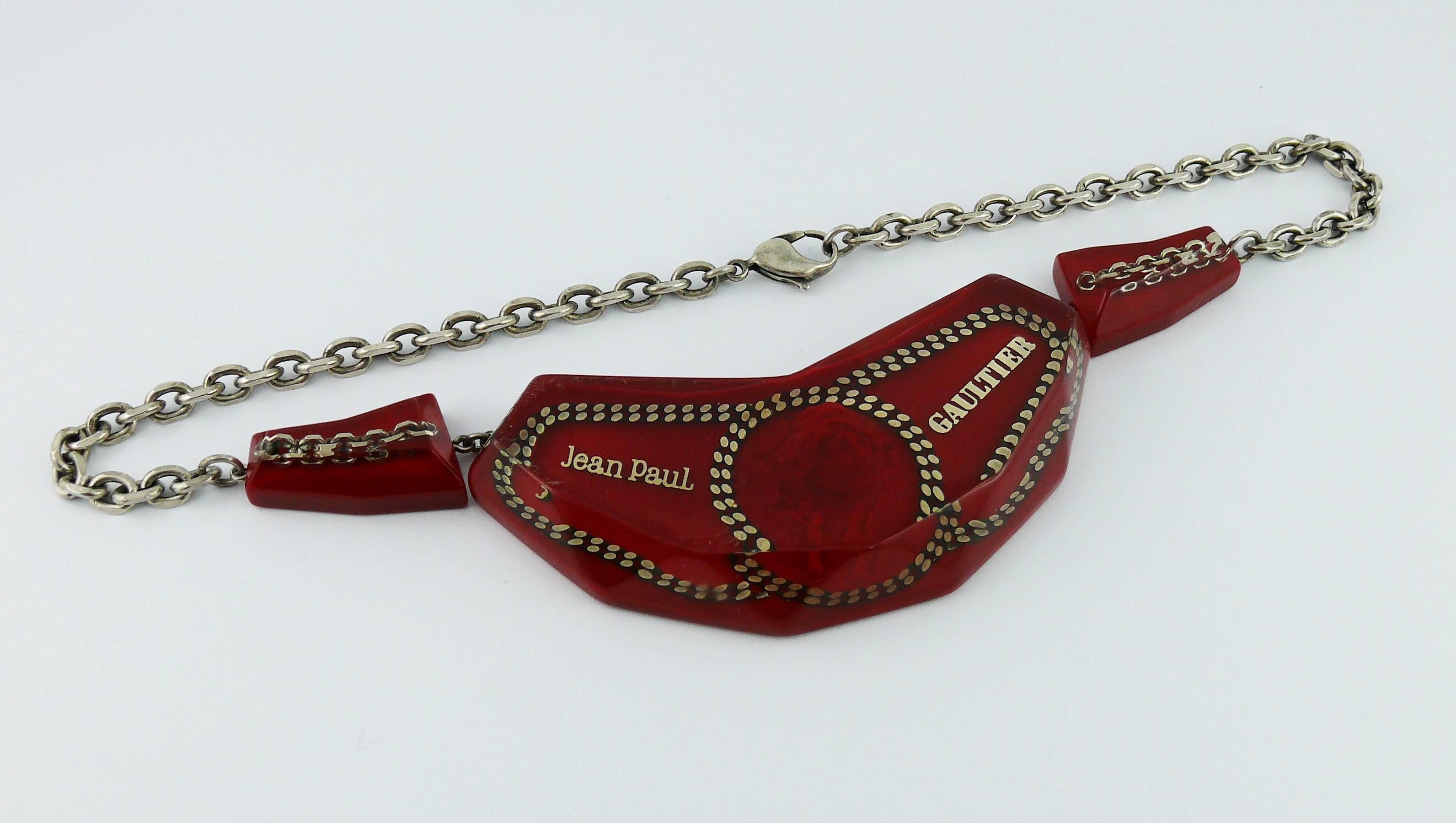JEAN PAUL GAULTIER triptych necklace featuring clear and red resin elements with chain inlaid. Central element is marked JEAN PAUL GAULTIER and features a 3-D woman profile.

Early 2000s.

Silver toned chaine.
Lobster clasp closure.

Indicative