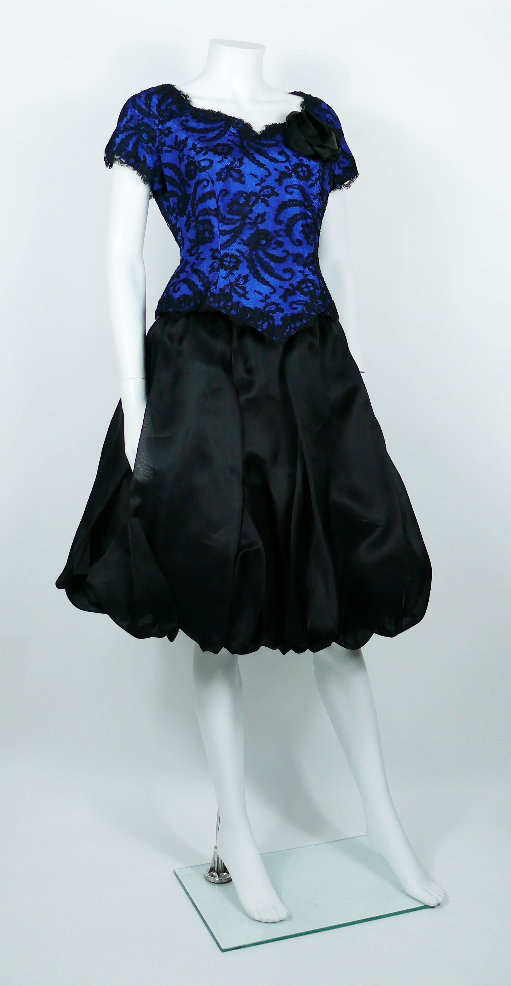 CHRISTIAN LACROIX vintage cocktail ensemble featuring a blue satin lace overlay bustier and a black organza puffball skirt.

BUSTIER features :
- Blue satin with black lace overlay.
- Black satin flower.
- Short sleeves. 
- Hidden back zipper.
-