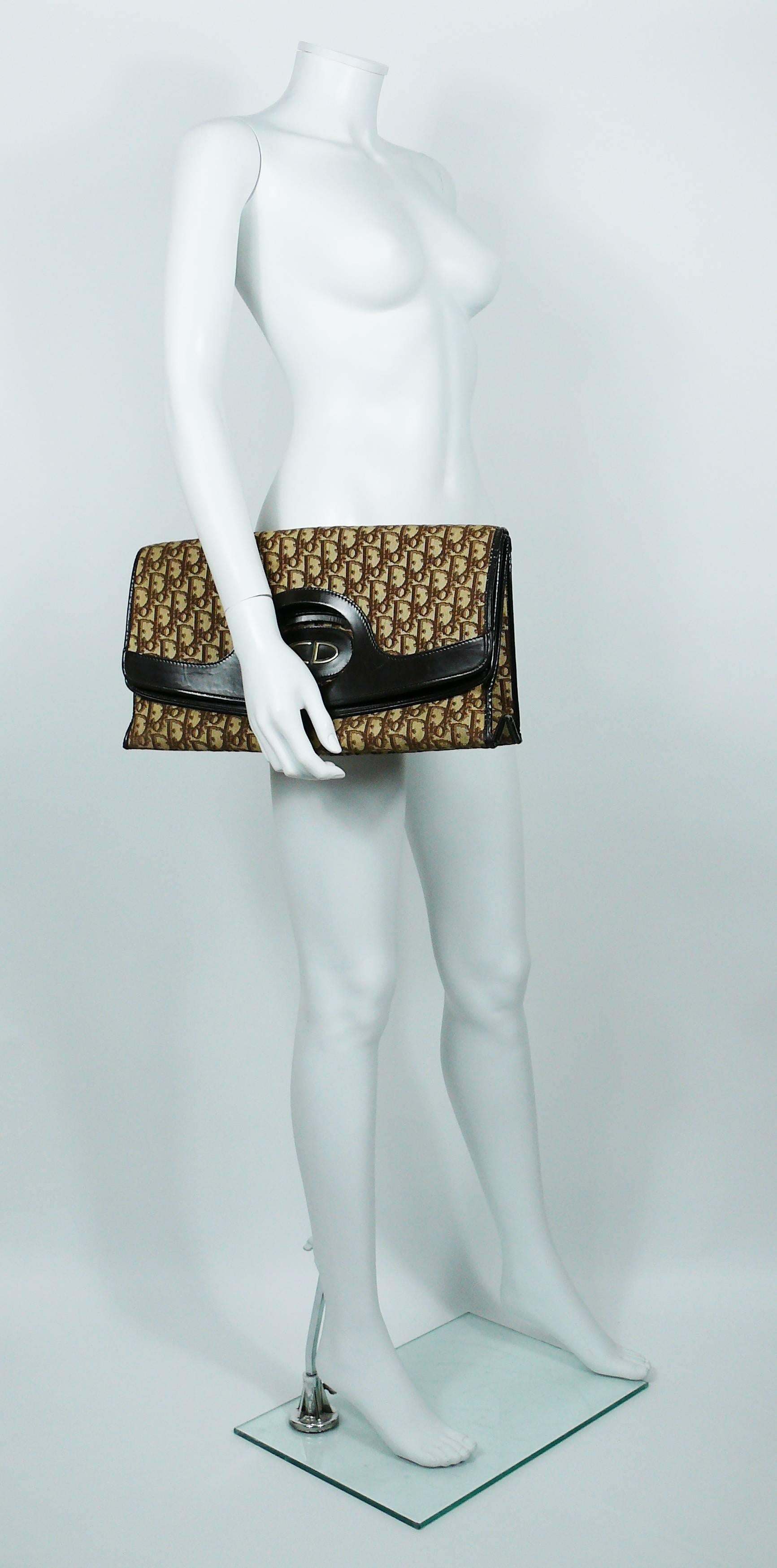 CHRISTIAN DIOR iconic vintage bag featuring brown monogram canvas on a off-white background, brown leather and gold toned CD monogram.

This is a rare XL version and a versatile piece that may be worn as a tote or clutch.

One inner pocket.

Marked
