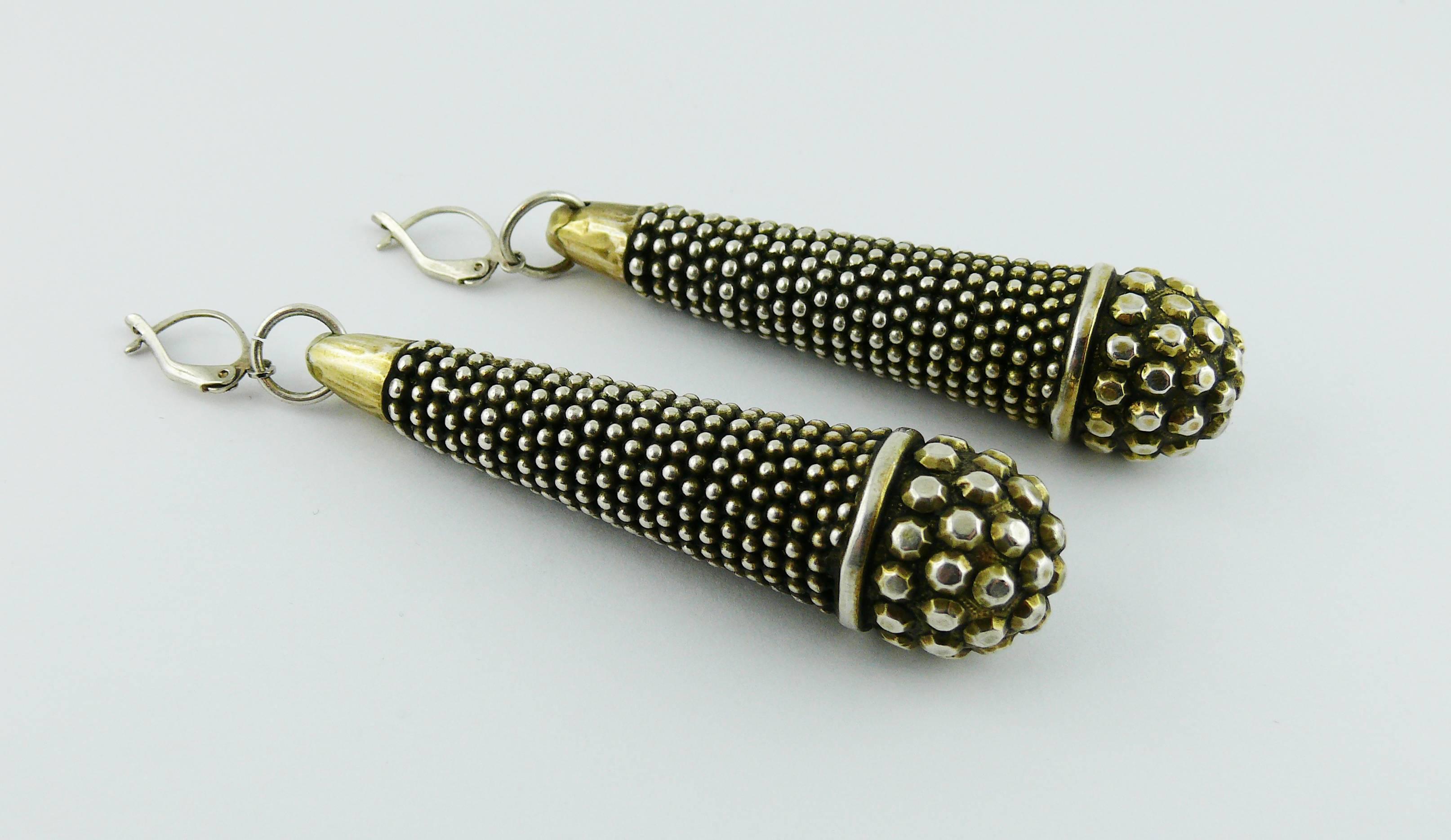 JEAN PAUL GAULTIER vintage massive ethnic inspired silver toned with patina pierced earrings featuring a tubular form with bead pattern design.

Embossed JPG.

Indicative measurements : length approx. 7.5 cm (2.95 inches) / max. width approx. 1.5 cm