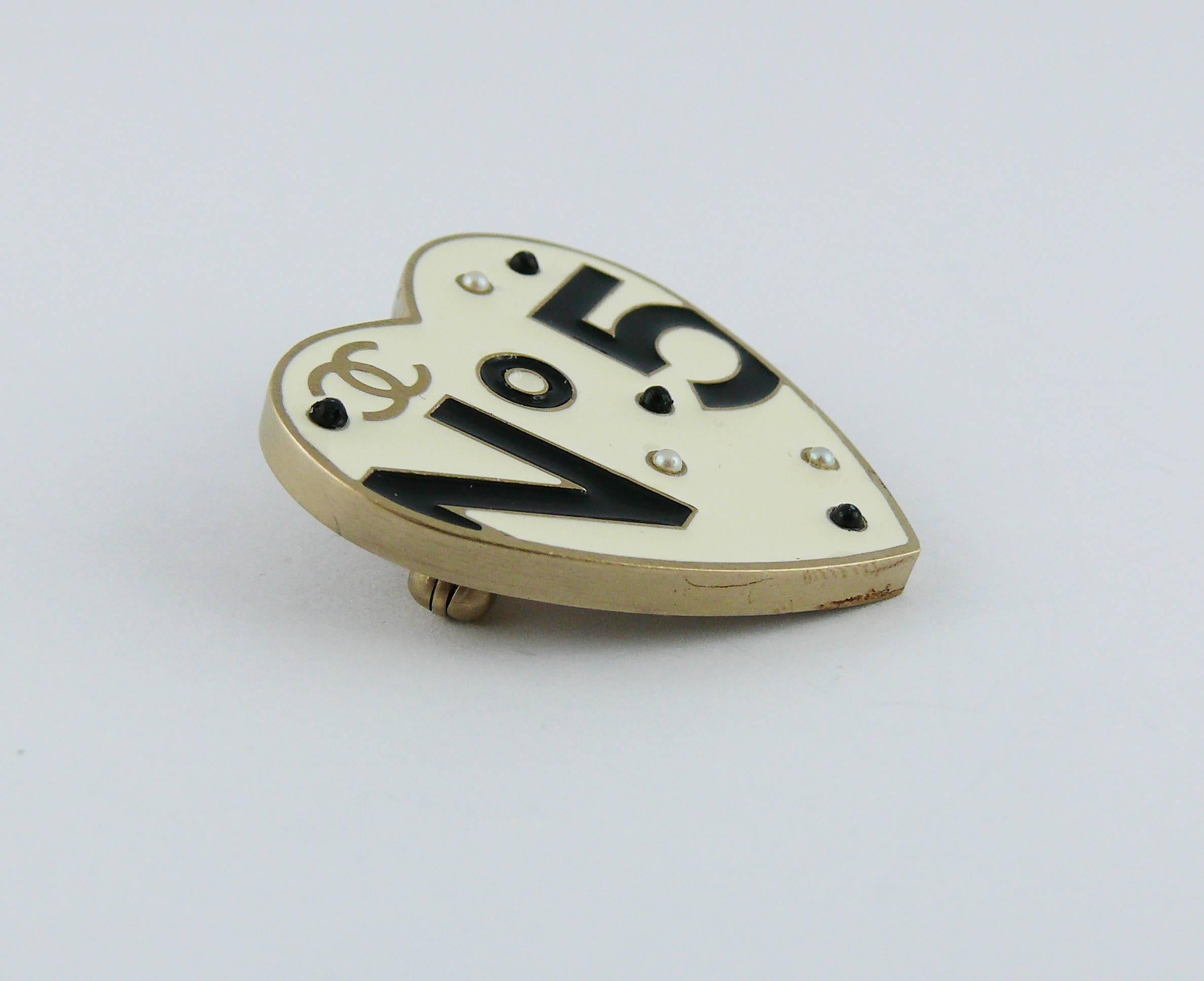CHANEL No. 5 enamel heart brooch featuring interlocking CC monogram, faux pearls and black cabochons.

Spring/Summer 2006 Collection.

Can be worn as a pendant.

Marked CHANEL 06P Made in Italy.

Indicative measurements : max. length approx. 3.1 cm
