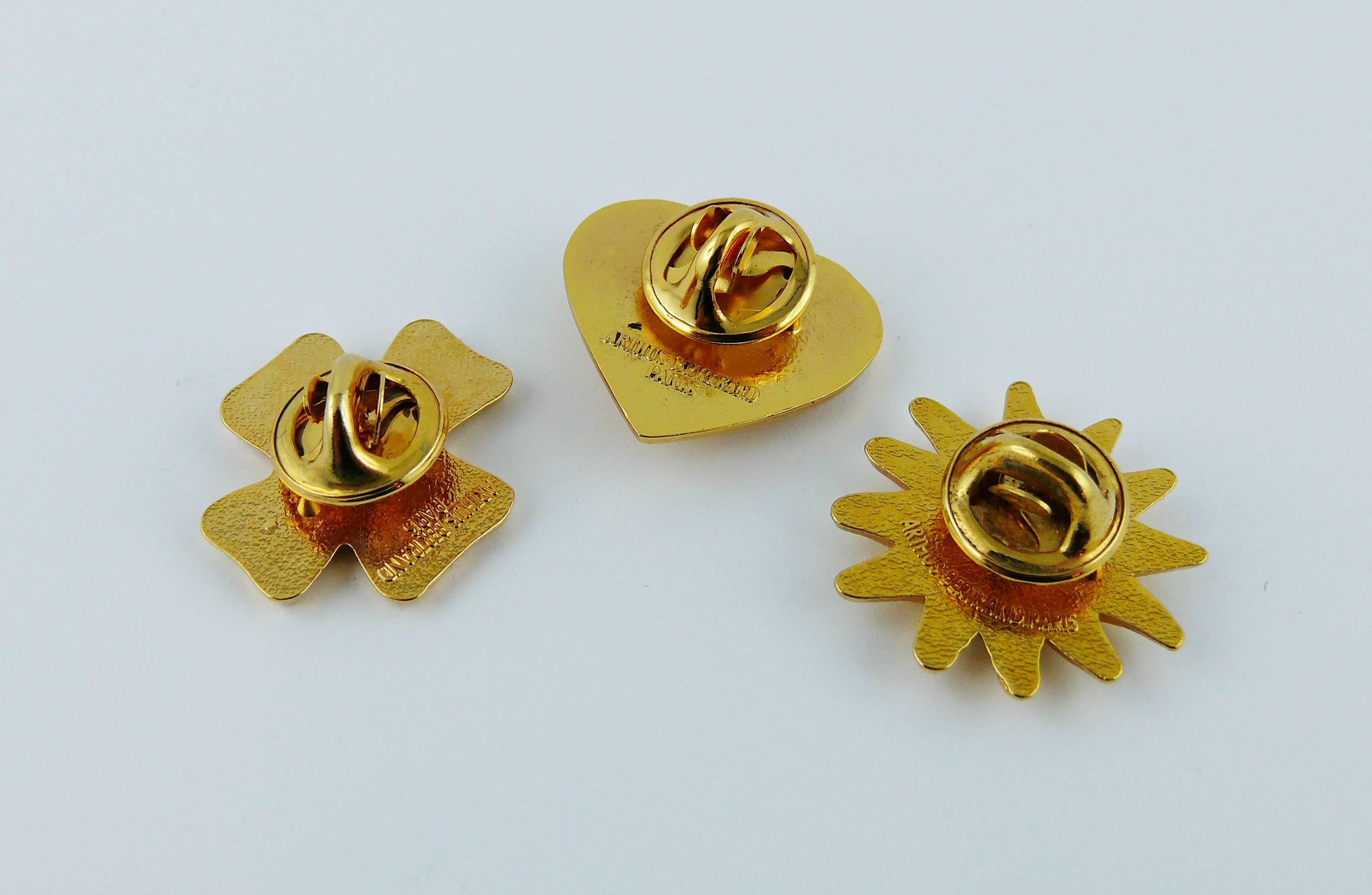 CHRISTIAN LACROIX vintage set of three gold toned iconic symbols pin brooches featuring heart, sun and cross.

Embossed CL.
Marked on the reverse ARTHUS BERTRAND Paris.

Indicative measurements : sun approx. 2.4 cm x 2.3 cm (0.94 x 0.91 inch) /