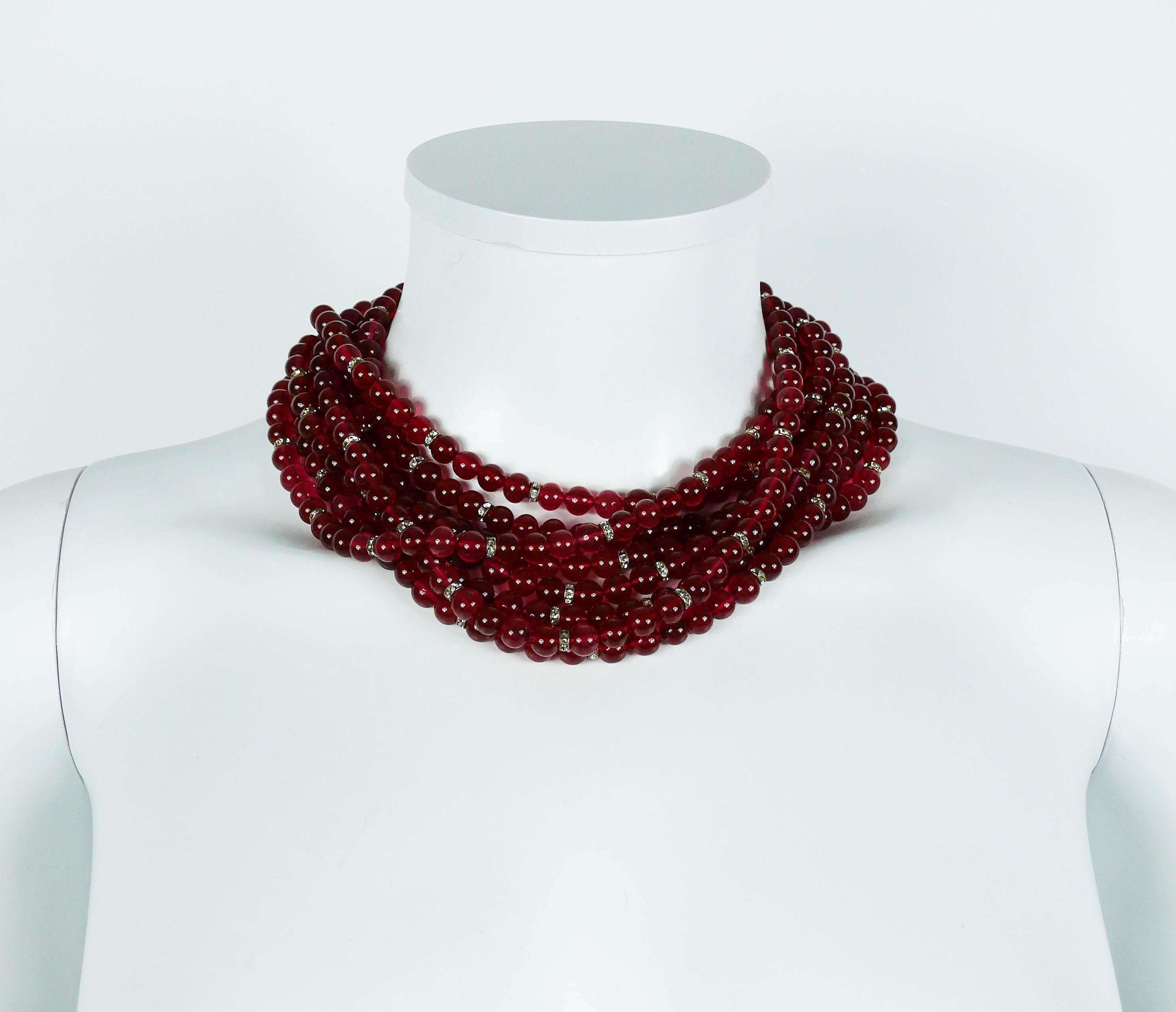 CHANEL vintage multi-strand necklace featuring ruby glass beads and clear crystal rondelles.

Circa 1971-1980.

Gorgeous openwork design gold toned clasp with clear crystal embellishement.

Hook clasp.
Extension chain.

Marked CHANEL Made in