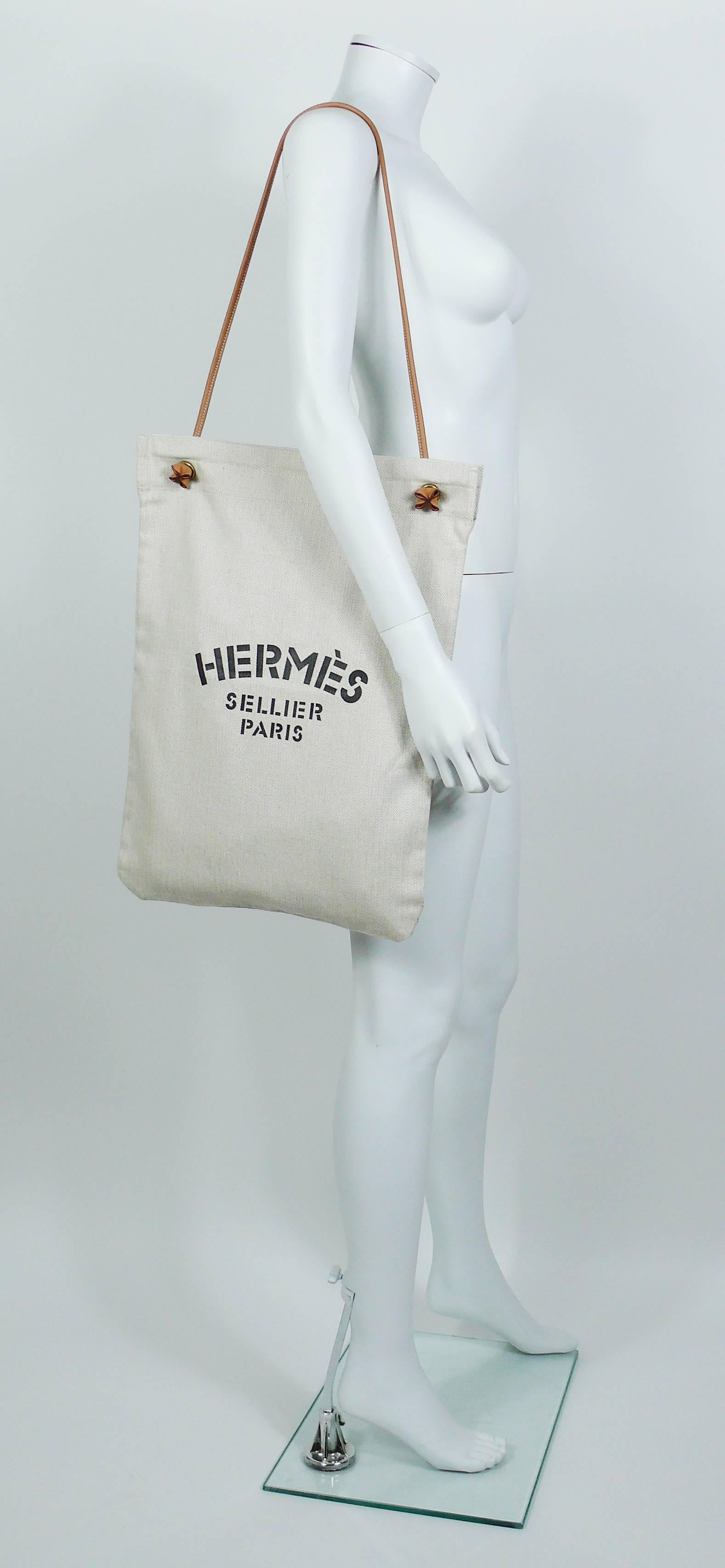 HERMES vintage Aline XL canvas tote bag with "HERMES Sellier Paris" print and brown leather strap.

Label reads HERMES Paris Made in France.

Composition : Cotton / Leather.

Indicative measurements : total height (incl. strap) approx. 80