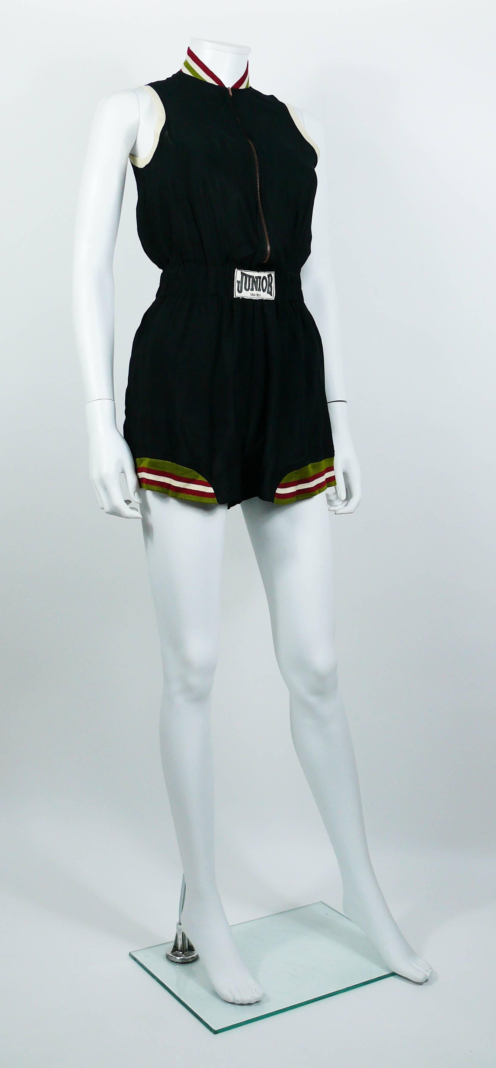 JEAN PAUL GAULTIER vintage rare 1990s black shortall inspired by boxing outfits.

This shortall features :
- Black viscose with multicolored knitted striped details.
- Short sleeves.
- Short shorts.
- Elastic waistband with Junior Gaultier patch at