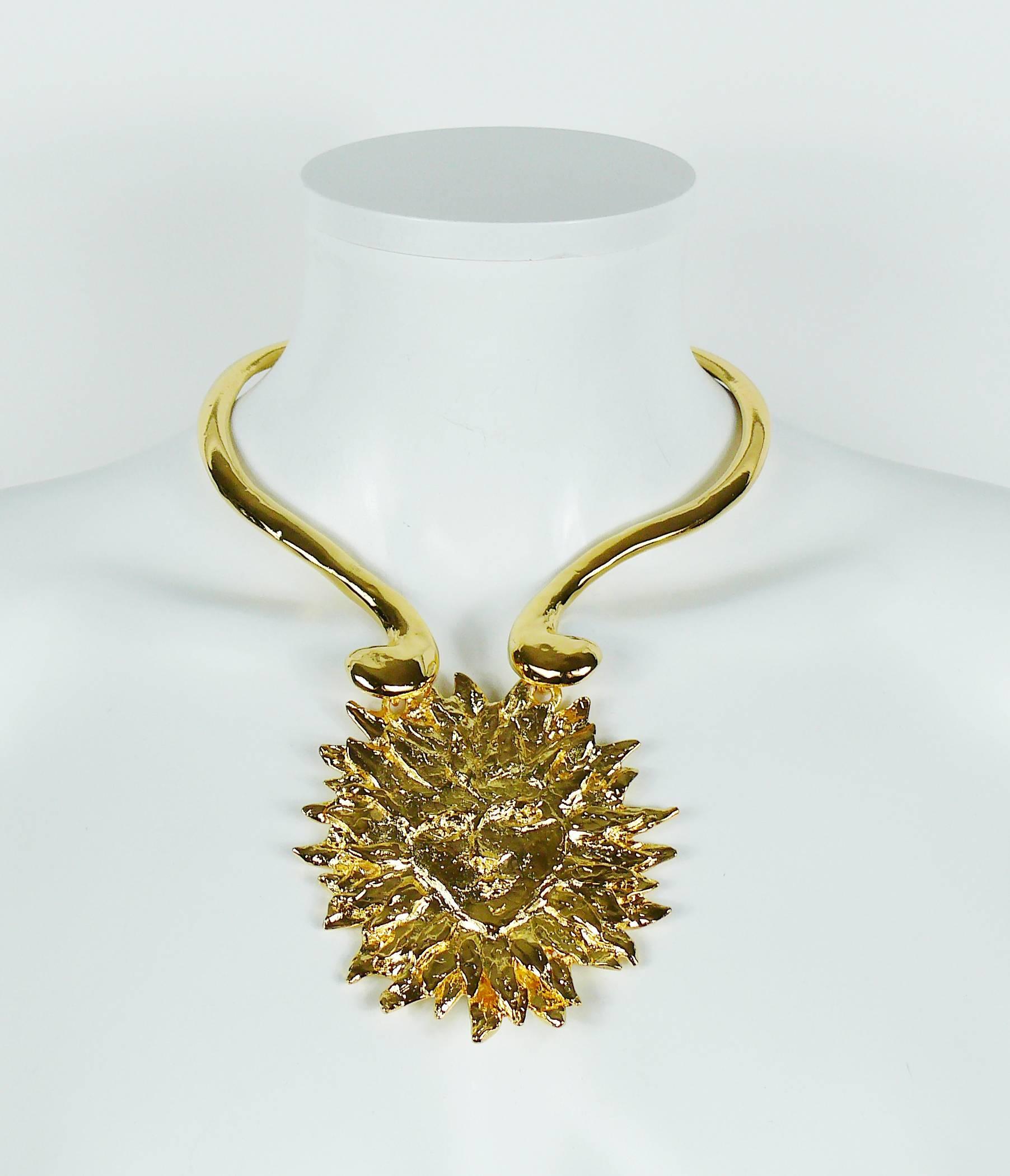 YVES SAINT LAURENT vintage rare gold toned iconic sun face chocker necklace created by ROBERT GOOSSENS, circa 1980s.

This necklace features a rigid collar with a massive 3D textured sun face pendant.

Hook closure.
Extension chain.

A similar