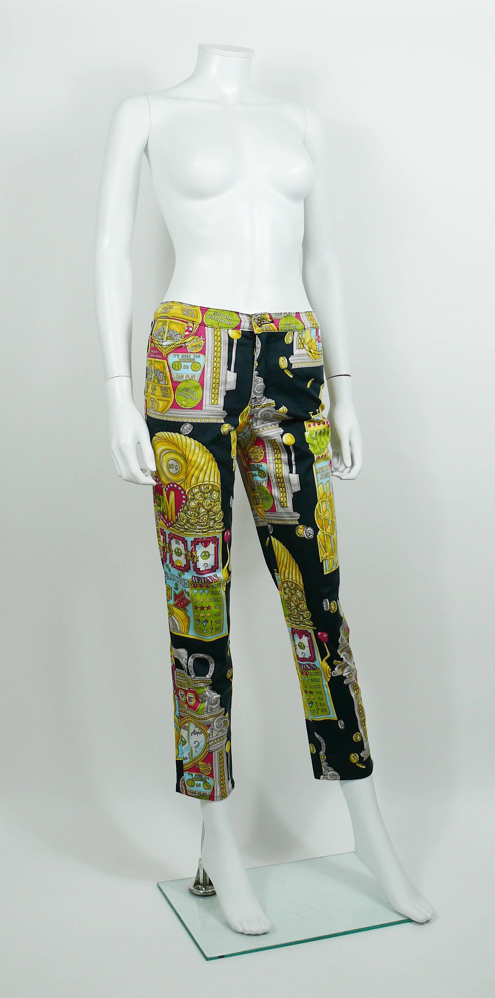 MOSCHINO vintage 1990s trousers featuring an opulent multicolored slot machine print on a black background.

These trousers feature :
- Stretchy material.
- Front buttoning and zip.
- MOSCHINO JEANS signature gold toned button and rivets.
- Four